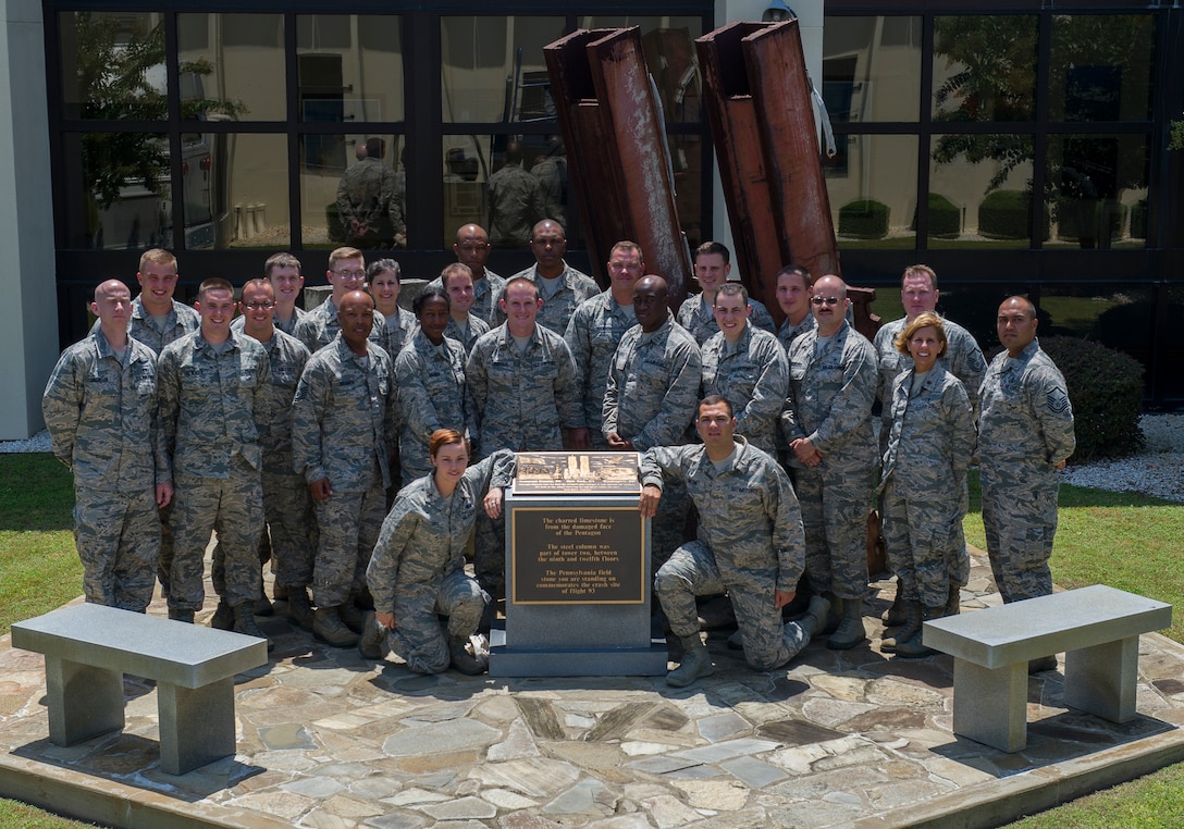 Applicants of the Chaplain Candidacy Program and their cadre pose for a photo in front of the 911 Memorial Aug. 7at the 601st Air Operations Center on Tyndall, AFB. The candidates visited Tyndall as a part of their 35 day intensive internship in which the candidates visit several different military bases to get a sense of the diversity of jobs and lifestyles in the Air Force. (U.S. Air Force photo by Senior Airman Alex Echols/Released)