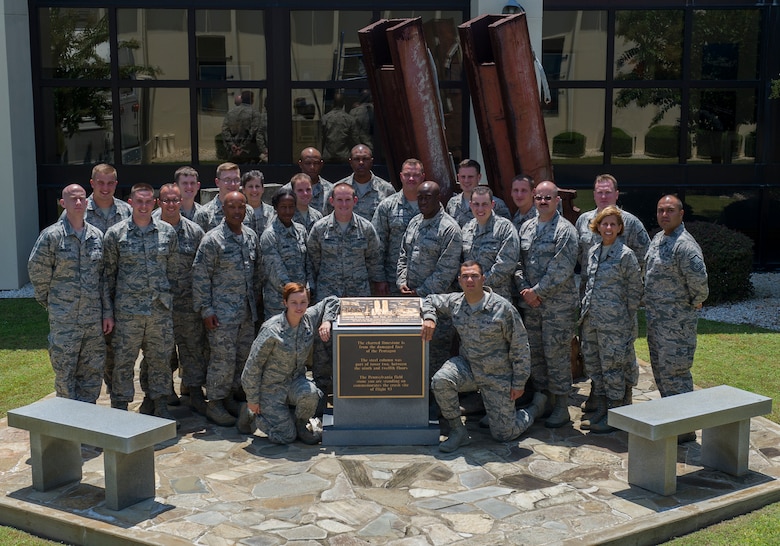 Applicants of the Chaplain Candidacy Program and their cadre pose for a photo in front of the 911 Memorial Aug. 7at the 601st Air Operations Center on Tyndall, AFB. The candidates visited Tyndall as a part of their 35 day intensive internship in which the candidates visit several different military bases to get a sense of the diversity of jobs and lifestyles in the Air Force. (U.S. Air Force photo by Senior Airman Alex Echols/Released)