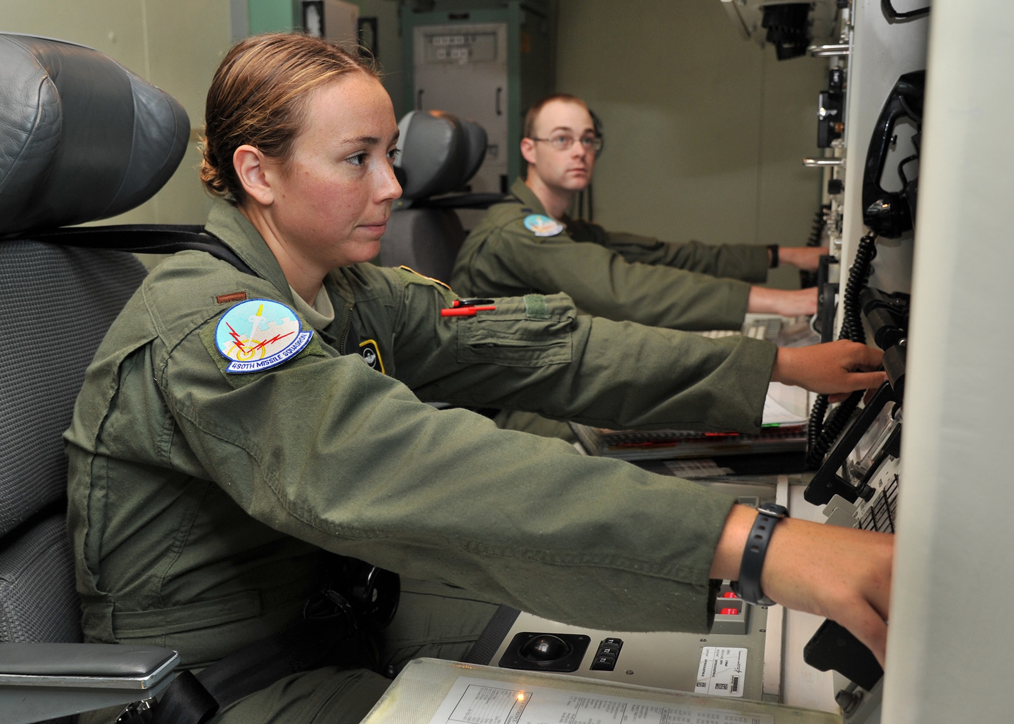 2nd Lt. Angelica Phillips, 490th Missile Squadron deputy crew commander, left, and 1st Lt. Joseph Whelan, 490th MS crew commander, practice coordination of an Emergency War Order action in the missile procedures trainer Aug. 8, 2015, during a training session at Malmstrom Air Force Base, Mont., for Global Strike Challenge 2015. The crew is one of three from the 341st Operations Group that will compete Aug. 31 against Minot AFB, N.D., and F.E. Warren AFB, Wyo., in Air Force Global Strike Command’s annual ICBM Operations competition. (U.S. Air Force photo/ John Turner)
