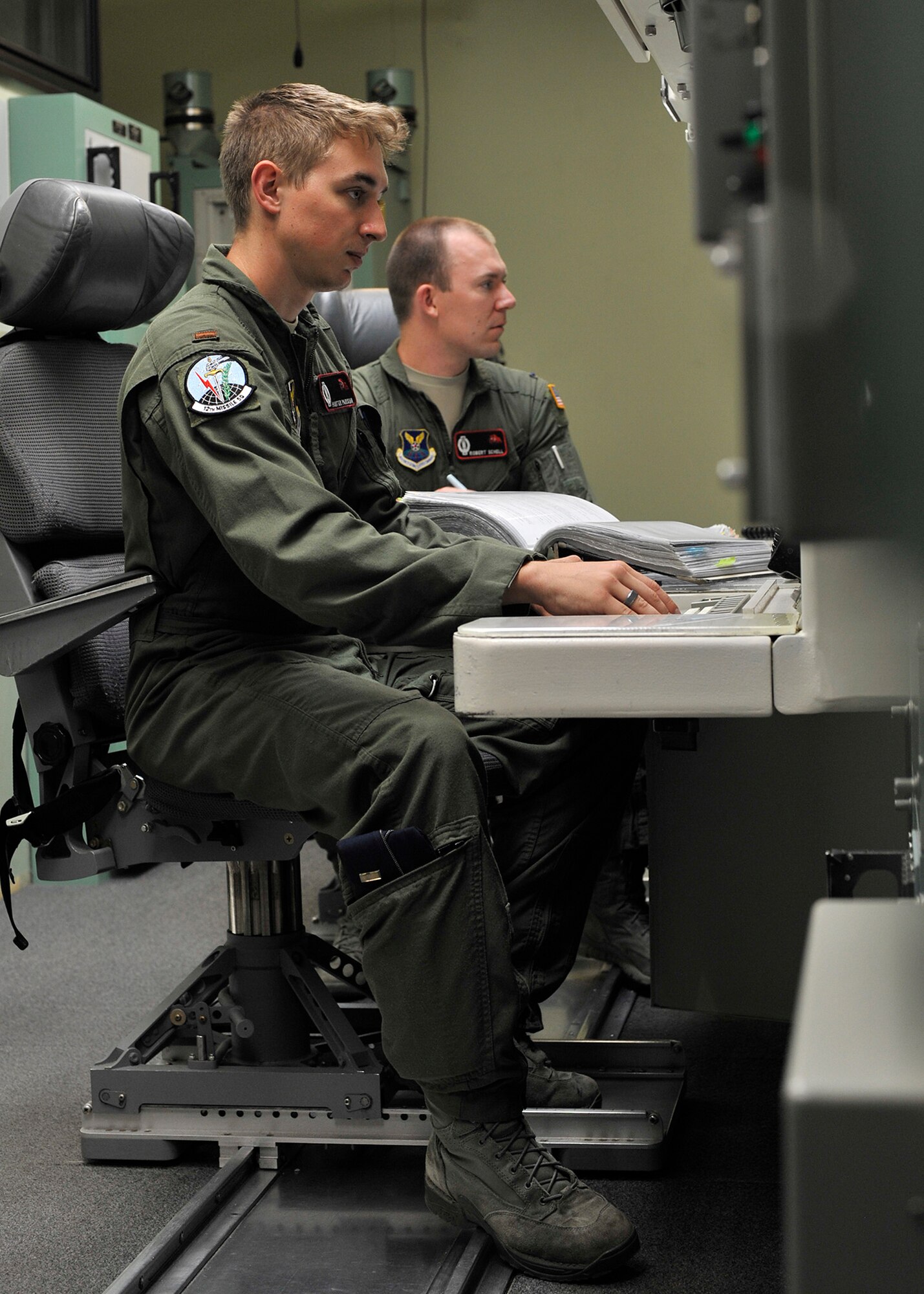 2nd Lt. Hunter Parisian, 12th Missile Squadron deputy crew commander, left, and 1st Lt. Robert Schell, 12th MS crew commander, run a simulated emergency drill in the missile procedures trainer Aug. 8, 2015, during a training session at Malmstrom Air Force Base, Mont., for Global Strike Challenge 2015. The crew is one of three from the 341st Operations Group that will compete Aug. 31 against Minot AFB, N.D., and F.E. Warren AFB, Wyo., in Air Force Global Strike Command’s ICBM Operations competition. (U.S. Air Force photo/ John Turner)