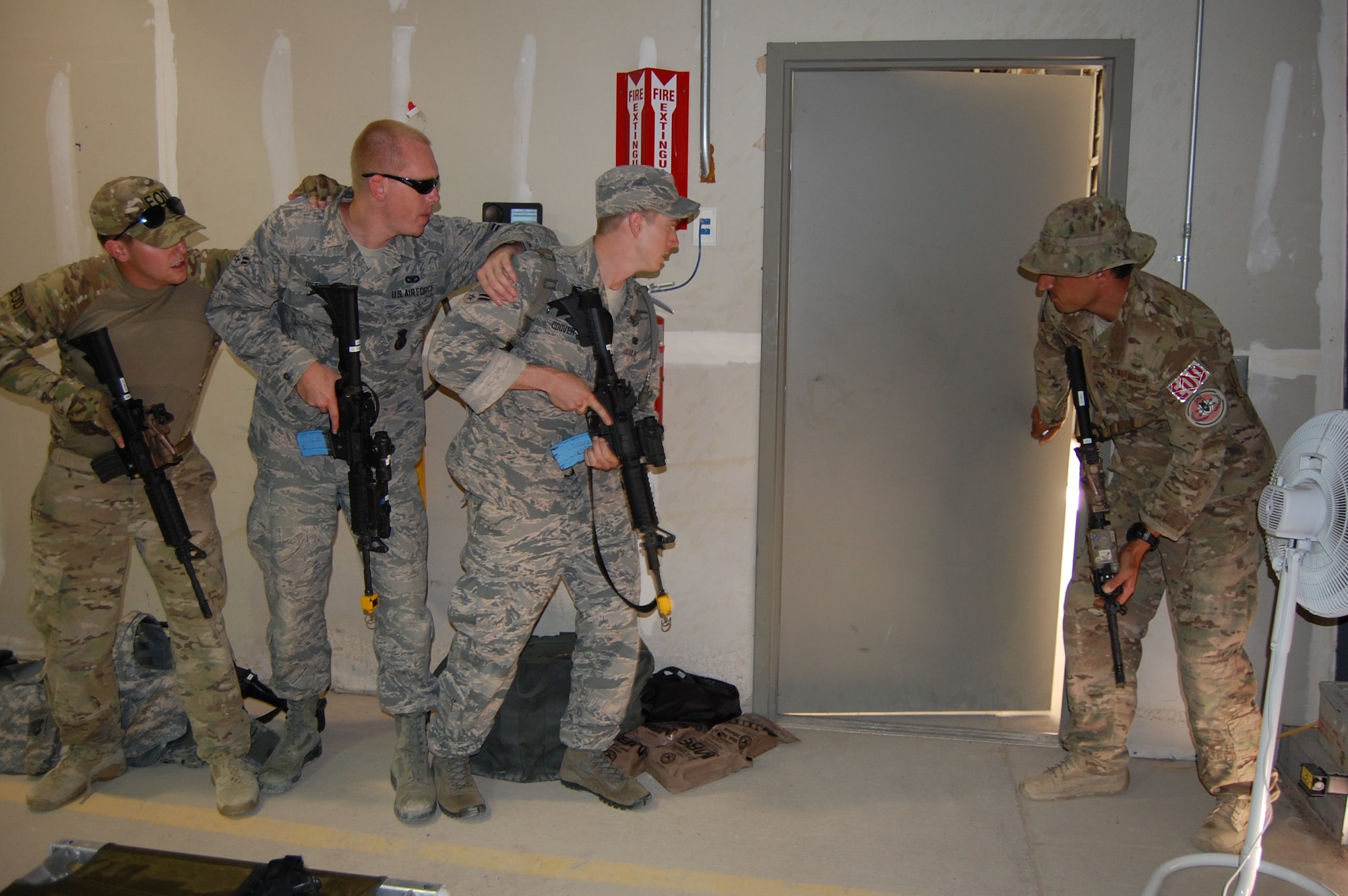 Members of the140th Explosive Ordnance Disposal Flight and the140th Security Forces Squadron, 140th Wing, Colorado Air National Guard, train on building clearance techniques during a joint training day August 5 at Airburst Range, Fort Carson, Colo. (US Air National Guard photo by Capt. Kinder Blacke)