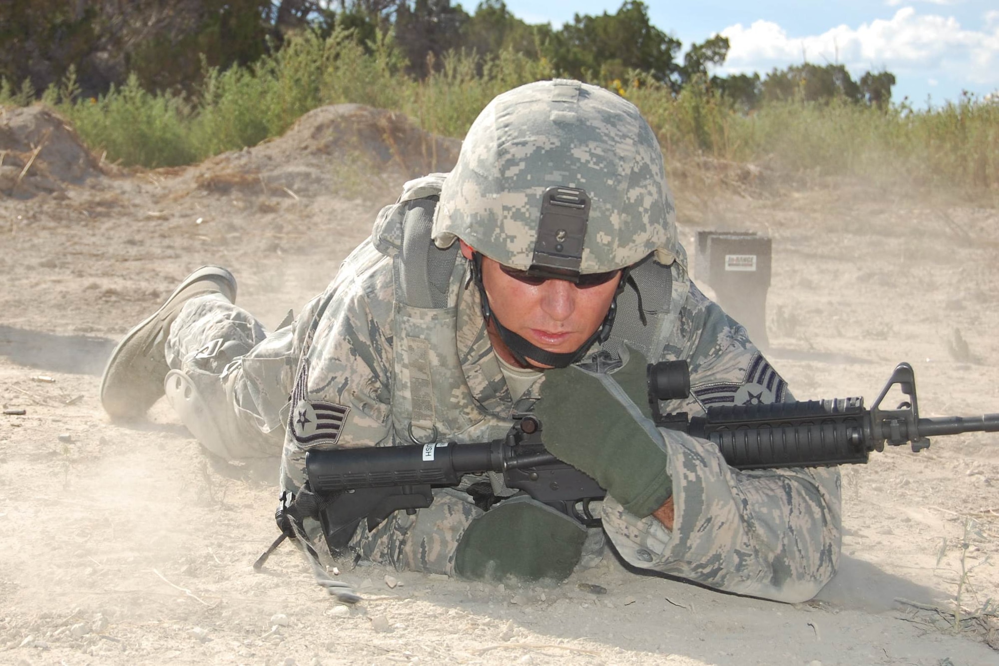 Members of the140th Explosive Ordnance Disposal Flight and the140th Security Forces Squadron, 140th Wing, Colorado Air National Guard, accomplish annual shooting qualifications on a 'shoot, move and communicate' course during a joint training day August 5 at Airburst Range, Fort Carson, Colo. (US Air National Guard photo by Capt. Kinder Blacke)