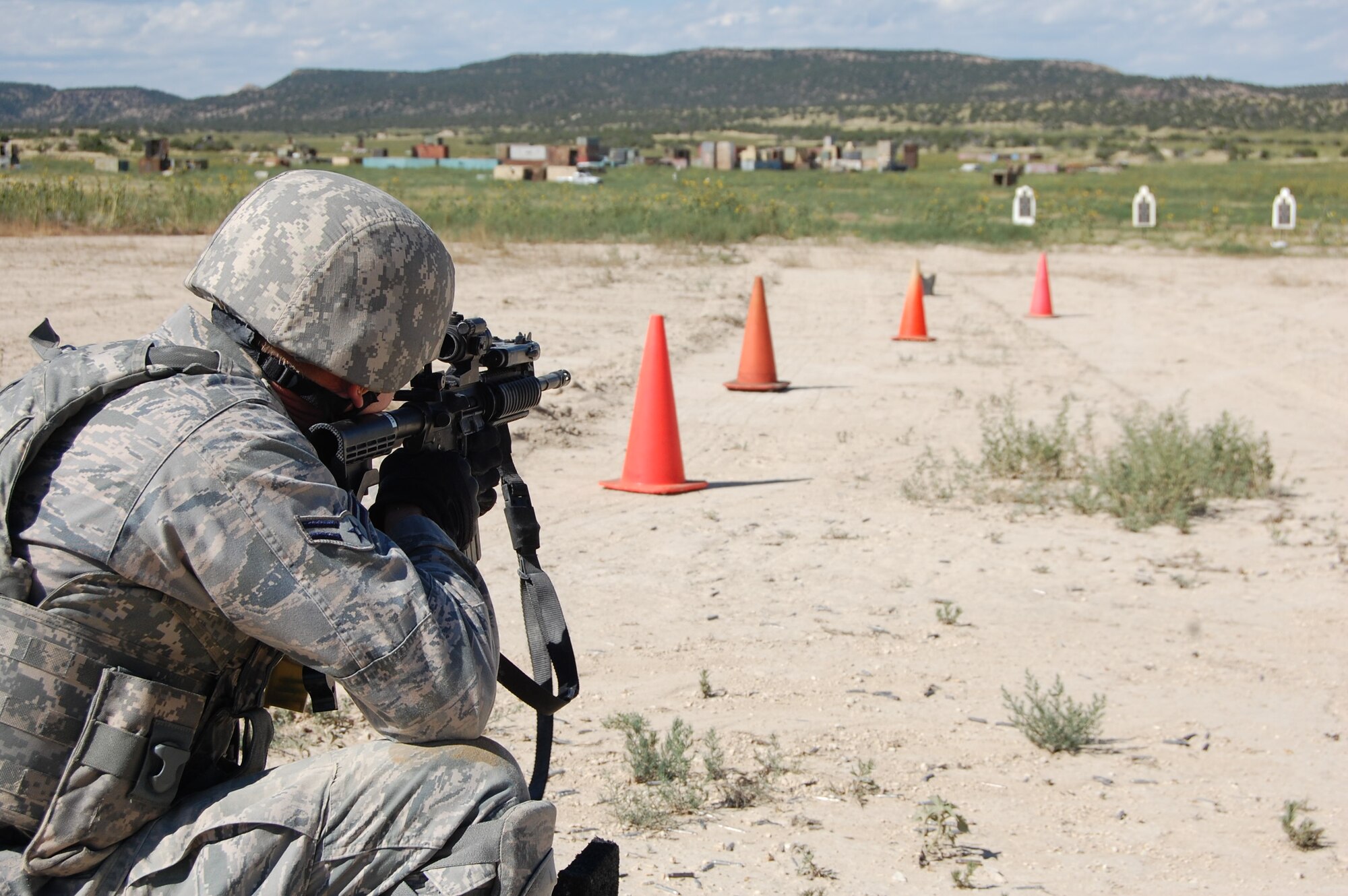 Members of the140th Explosive Ordnance Disposal Flight and the140th Security Forces Squadron, 140th Wing, Colorado Air National Guard, accomplish annual shooting qualifications on a 'shoot, move and communicate' course during a joint training day August 4 at Airburst Range, Fort Carson, Colo. (US Air National Guard photo by Capt. Kinder Blacke)