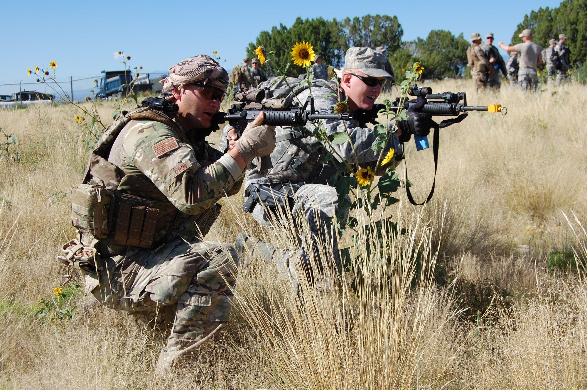 Staff Sgt. Robert Rich, EOD operator, 140th Explosive Ordnance Disposal Flight, exercises squad movement tactics with Airman First Class Dalton Detwiler, patrolman, 140th Security Forces Squadron, 140th Wing, Colorado Air National Guard, during a joint training day August 4 at Airburst Range, Fort Carson, Colo. (US Air National Guard photo by Capt. Kinder Blacke)