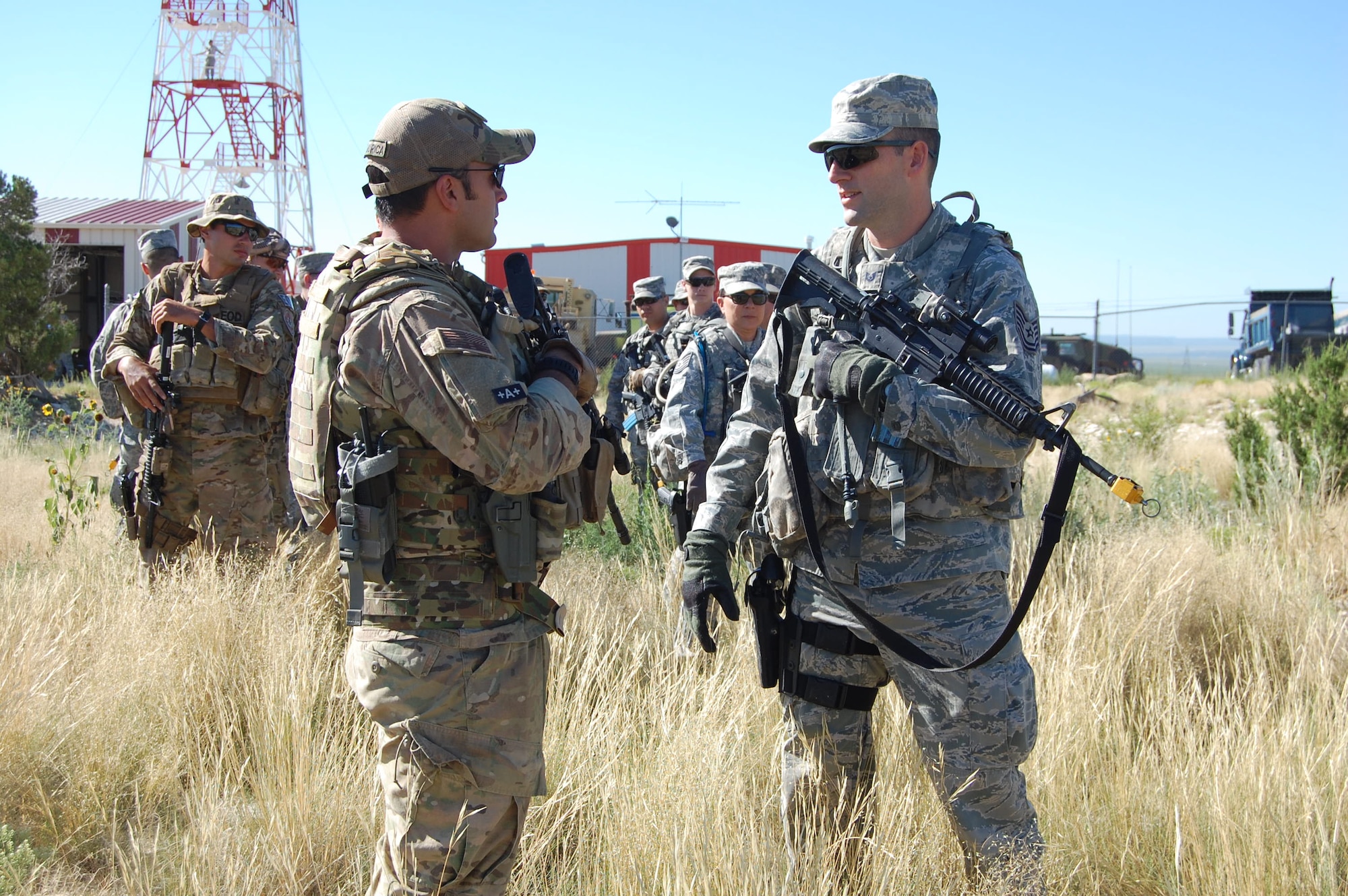 Master Sgt. Richard "Dick" Gibbons, EOD flight chief, 140th Explosive Ordnance Disposal Flight, works with Tech. Sgt. Andrew Wise, patrolman, 140th Security Forces Squadron, 140th Wing, Colorado Air National Guard, on squad movement tactics during a training day August 4 at Airburst Range, Fort Carson, Colo. (US Air National Guard photo by Capt. Kinder Blacke)