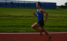 Capt. Daniel Castle, 349th Air Refueling Squadron pilot, runs on the half-mile track, Aug. 14, 2015, at McConnell Air Force Base, Kan. Castle runs each day to contribute to his goal of being an Olympic 1500 meter runner. (U.S. Air Force photo by Airman 1st Class Christopher Thornbury)