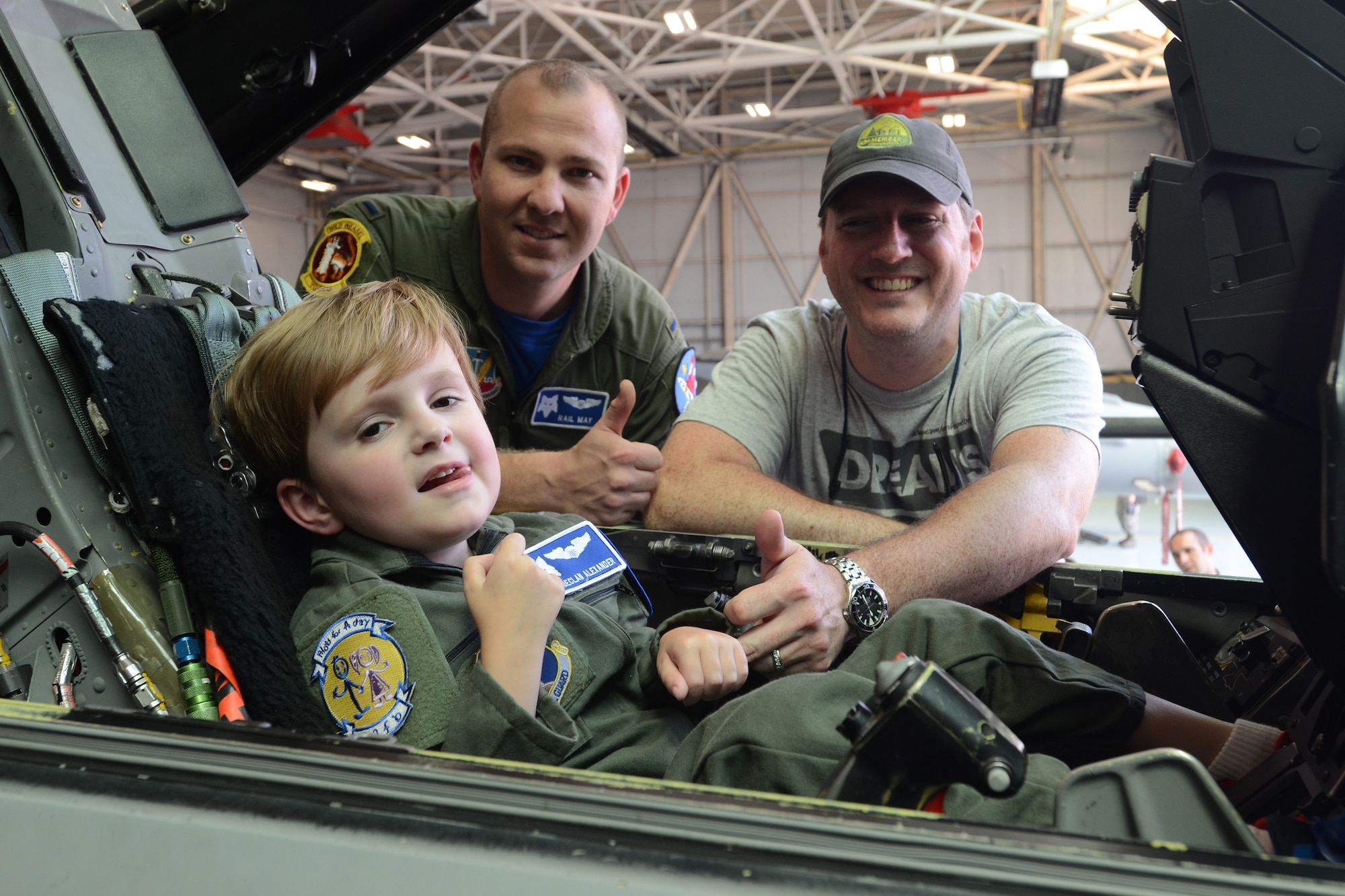 Declan Alexander sits in an F-16 Fighting Falcon at McEntire Joint National Guard Base, Eastover, S.C., as the Swamp Fox “Pilot for a Day”, Aug. 15, 2015. Declan spent the day with U.S. Air Force 1st Lt. Cody "Rail" May, a fighter pilot with the 157th Fighter Squadron, and watched F-16 fighter jets land, toured aircrew flight equipment, sat in the cockpit of an F-16, and took a ride in a fire truck. The Pilot for a Day program is an opportunity for disadvantaged or seriously ill children to spend a day with members of the South Carolina Air National Guard. (S.C. Air National Guard photo by Airman 1st Class Ashleigh Pavelek/Released)