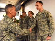 Airmen Against Drunk Driving volunteers receive commander's coins from Col. John Wilcox, 341st Missile Wing commander, Aug. 19. The Airmen were recognized for their contribution to the AADD program and displaying exemplary core values in their day-to-day duties. (U.S. Air Force photo/Airman 1st class Collin Schmidt) 