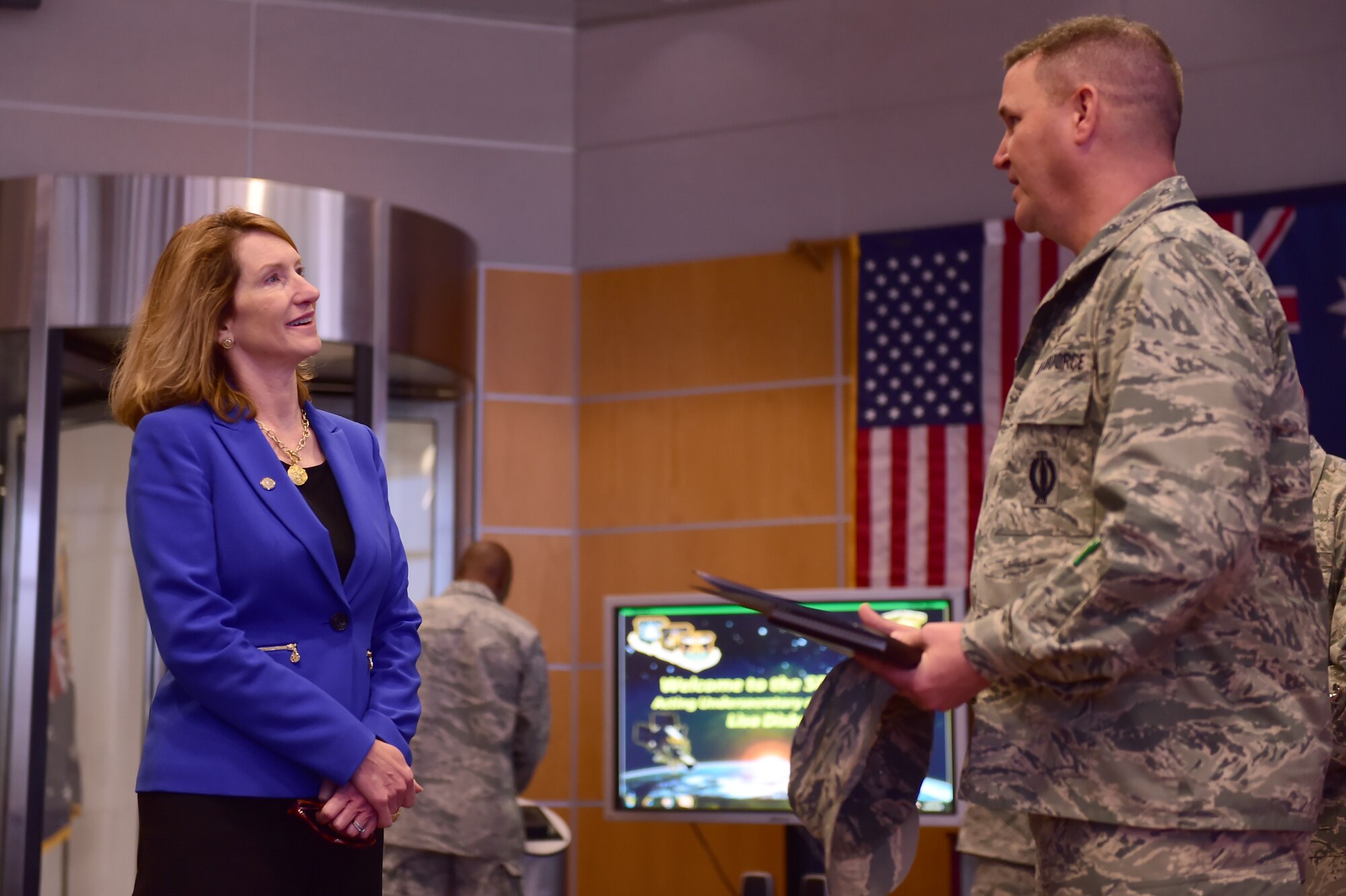 Lisa Disbrow, Action Under Secretary of the Air Force, is briefed on the capabilities of satellites by Col. Michael Jackson, 460th Operations Group commander, Aug. 18, 2015, on Buckley Air Force Base, Colo. (U.S. Air Force photo by Airman 1st Class Luke W. Nowakowski/Released) 