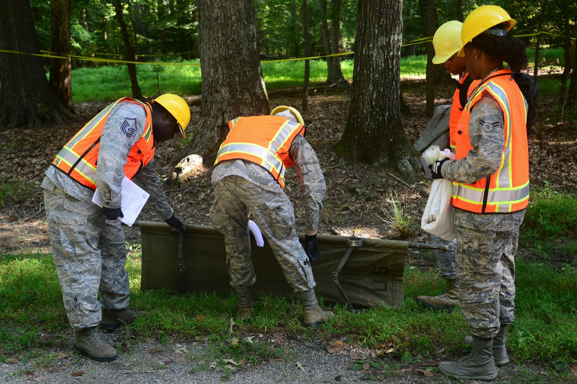 U.S. Air Force Airmen assigned to the 633rd Force Support Squadron prepare a gurney during a helicopter training exercise at Fort Eustis, Va., Aug. 13, 2015. Exercises prepare Airmen for real-world events that require a team to recover injured personnel and get them out of the area safely. (U.S. Air Force photo by Staff Sgt. Ciara Gosier/Released) 