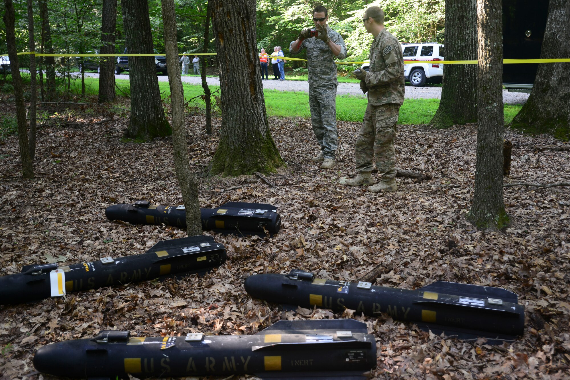 U.S. Air Force Airmen from the 633rd Civil Engineer Squadron Explosive Ordnance Disposal unit capture images of training missiles during a helicopter training exercise at Fort Eustis, Va., Aug. 13, 2015. EOD identified training hellfire missiles and accounted for and documented the location of the missiles during the exercise. (U.S. Air Force photo by Staff Sgt. Ciara Gosier/Released)     