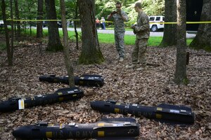 U.S. Air Force Airmen from the 633rd Civil Engineer Squadron Explosive Ordnance Disposal unit capture images of training missiles during a helicopter training exercise at Fort Eustis, Va., Aug. 13, 2015. EOD identified training hellfire missiles and accounted for and documented the location of the missiles during the exercise. (U.S. Air Force photo by Staff Sgt. Ciara Gosier/Released)     