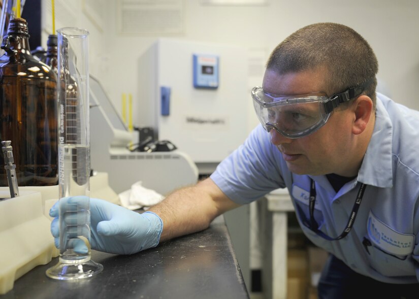 Kevin Miedzinski, 11th Logistics Readiness Squadron fuels technician, measures fuel for testing Aug. 19, 2015, on Joint Base Andrews, Md. Miedzinski tested the fuels system icing inhibitor which keeps the fuel from freezing at high altitudes.(U.S. Air Force photo by Senior Airman Preston Webb/RELEASED)