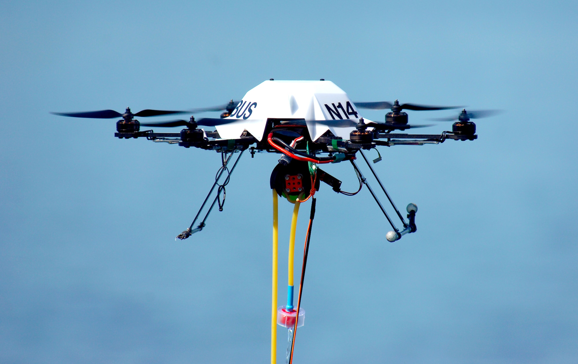 An Ascending Technologies Firefly hex-rotor unmanned aerial vehicle hovers over the Offutt Air Force Base lake August 12, 2015 while collecting water samples to test the density of Zebra Mussel larvae, called veligers, in the lake. Offutt’s lake is the only known lake in Nebraska to contain the invasive species and is being studies by the Nebraska Cooperative Fish and Wildlife Research Unit to improve control and eradication efforts. (U.S. Air Force photo by Delanie Stafford/Released)