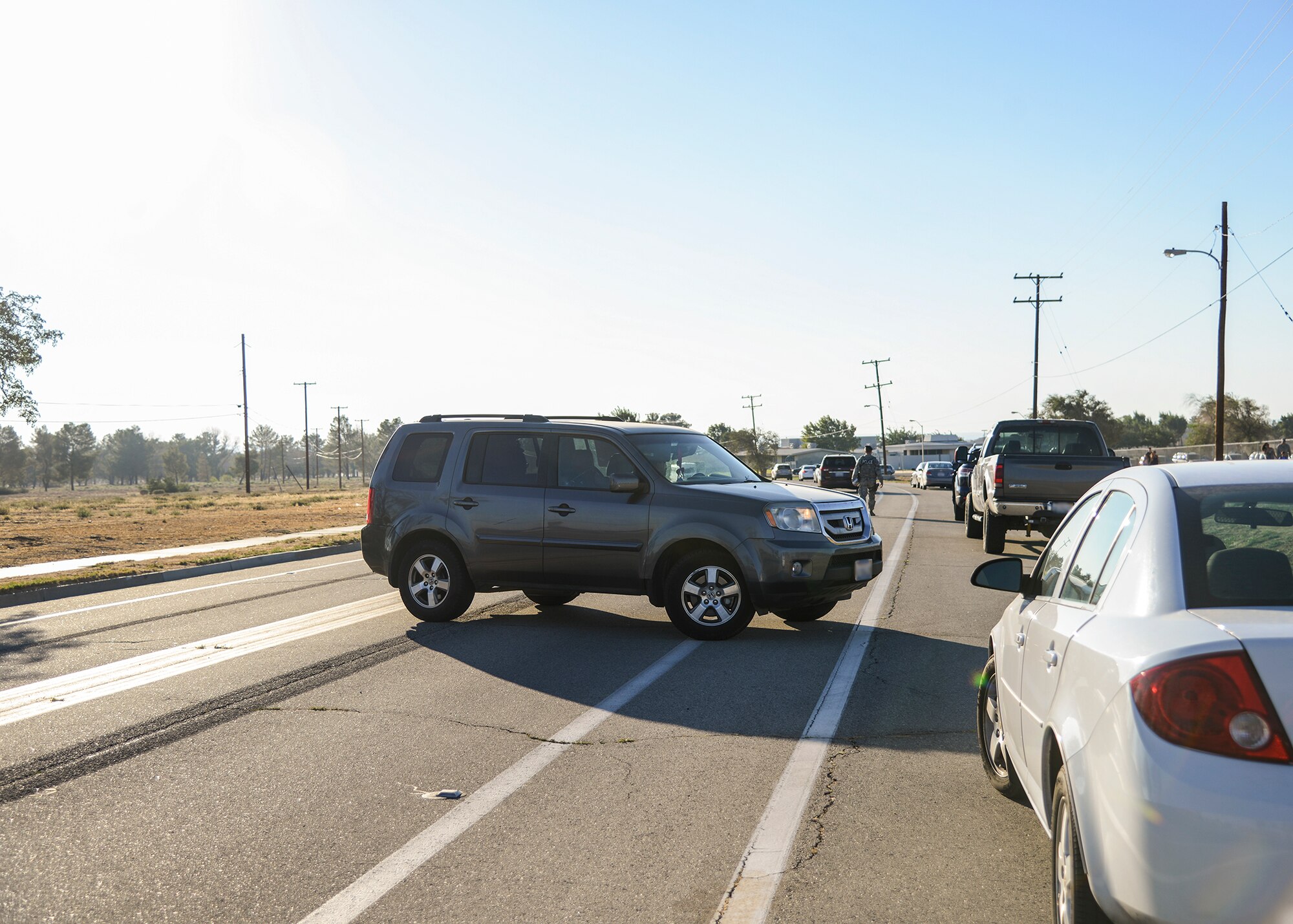 A driver makes an illegal U-turn to obtain a spot in the secondary drop-off lane by Branch Elementary School. The driver received corrective instruction from 412th Security Forces Squadron patrolmen; however, future instances will result in a citation. (U.S. Air Force photo by Rebecca Amber)