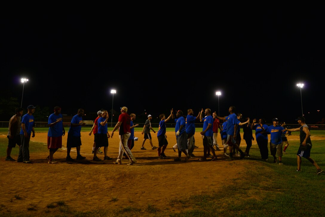 U.S. Army Training and Doctrine Command and 359th Inland Cargo Transfer Company Chaos teams congratulate each other after the Fort Eustis Intramural Softball championship game at Fort Eustis, Va., Aug. 14, 2015. After the games, each player was also awarded medals and congratulated by U.S. Army Col. William Galbraith, 733rd Mission Support Group commander. (U.S. Air Force photo by Staff Sgt. Natasha Stannard/Released)