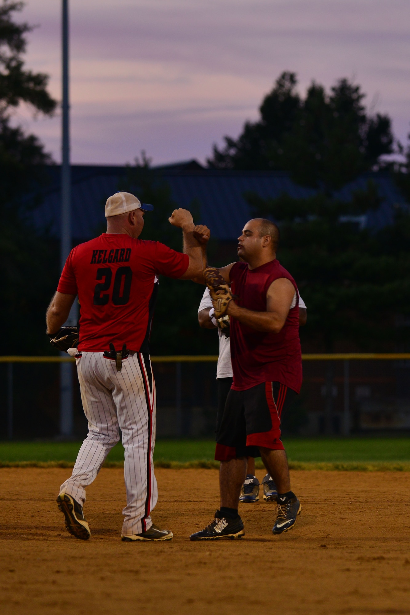 U.S. Army Staff Sgt. William Kelgard and Pfc. Chris Coro, 359th Inland Cargo Transfer Company Chaos teammates, celebrate striking out a U.S. Army Training and Doctrine Command team member during the Intramural Softball tournament championship game at Fort Eustis, Va., Aug. 14, 2015.  The 359th ICTC Chaos team and other intramural teams are made up of Service members and their families. (U.S. Air Force photo by Staff Sgt. Natasha Stannard/Released) 
