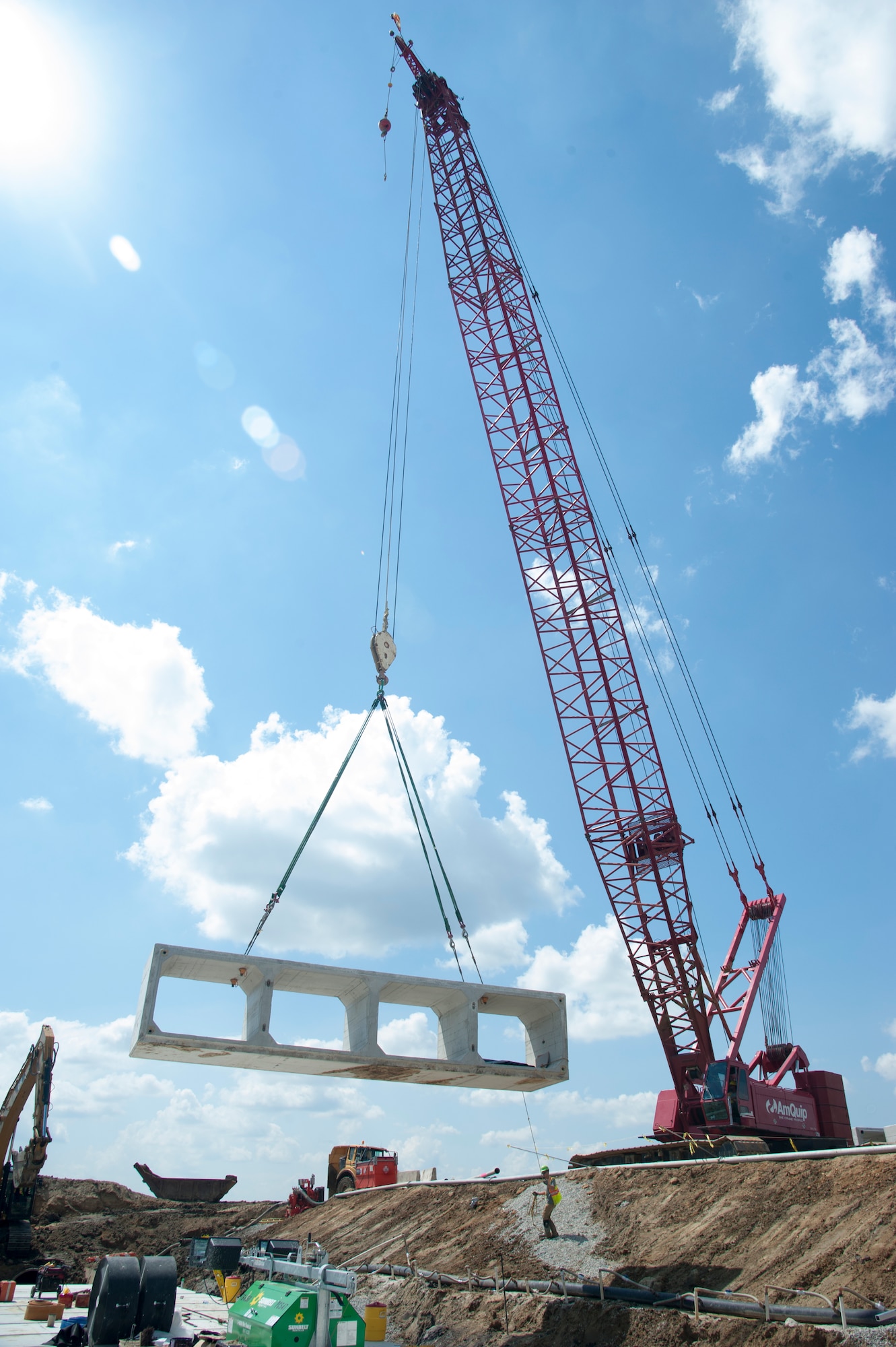 A crane operator maneuvers a concrete box on the flight line August 12, 2015, on Dover Air Force Base, Del.  Workers will replace more than 3,705 feet of reinforced concrete piping with concrete box culverts during the construction project. The work is part of a $98.3 million runway repair project. (U.S. Air Force photo/Senior Airman Jared Duhon)