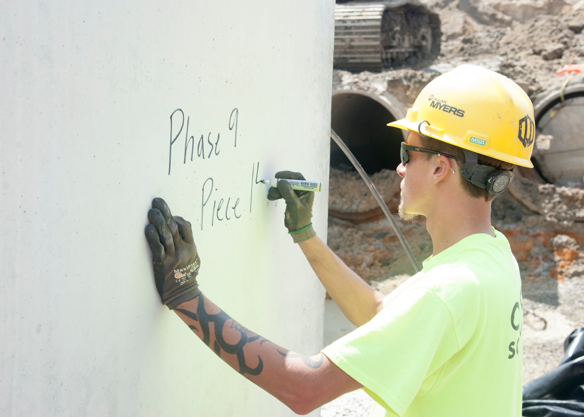 William Showacre, Allan Myers construction worker, writes on the concrete box culverts August 12, 2015, on Dover Air Force Base, Del. during Dover AFB’s $98.3M runway repair project.  The numbers signify the location and number of concrete boxes used in the current culvert section. (U.S. Air Force photo/Senior Airman Jared Duhon)