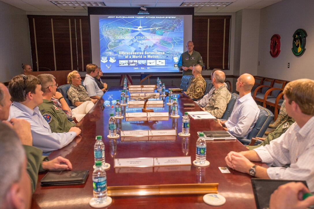 U.S. Air Force Col. Thomas Grabowski, vice commander of the 116th Air Control Wing (ACW), Georgia Air National Guard, briefs staff delegates from several Georgia congressional and senate offices along with leaders from the 116th ACW, 461st ACW and Army JSTARS during a visit where the delegates toured Team JSTARS and the E-8C Joint STARS aircraft during a visit to Robins Air Force Base, Ga., Aug. 18, 2015. During the visit, the delegates received a mission briefing updating them on the JSTARS program and an orientation tour of the aircraft. Team JSTARS; consisting of the 116th ACW, Georgia Air National Guard, the 461st ACW and Army JSTARS, is the sole location for the E-8C Joint STARS flying operation providing one-of-a-kind manned, battle management, command and control, intelligence, surveillance and reconnaissance support to combatant commanders around the globe. (U.S. Air National Guard photo by Senior Master Sgt. Roger Parsons/Released)