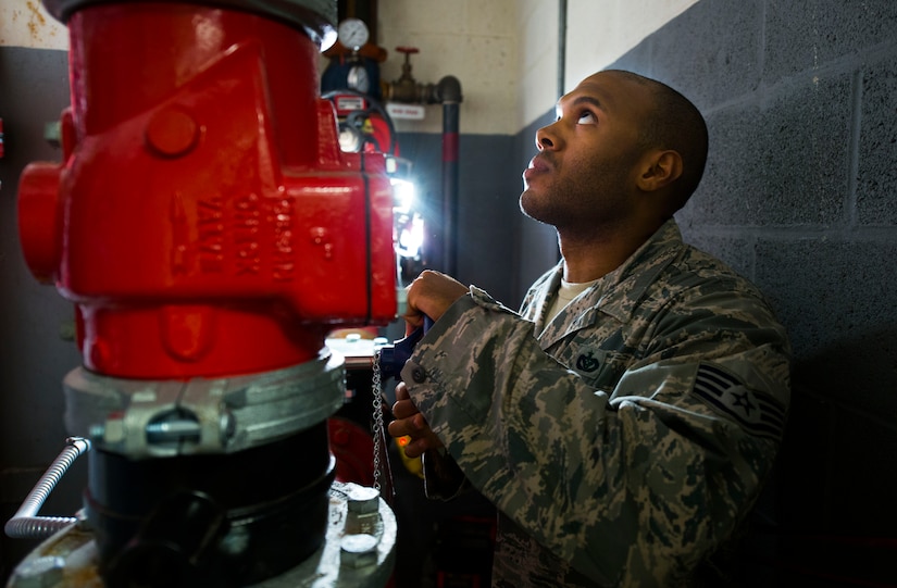 Staff Sgt. Lewis Thomas, 11th Civil Engineer Squadron water and fuels systems specialist, checks a pressure gauge at Hangar 13 on Joint Base Andrews, Md., Aug. 19, 2015. Thomas and his crew were repairing the facilities fire suppression system, which is crucial for hangars that store aircraft. (U.S. Air Force photo by Staff Sgt. Chad C. Strohmeyer)(Released)