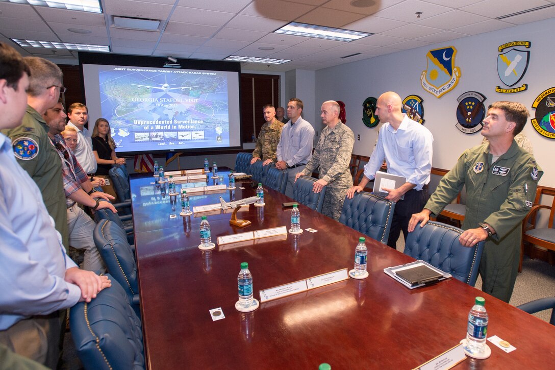 Leaders from the 116th Air Control Wing (ACW), 461st ACW and Army JSTARS meet with staff delegates from several Georgia congressional and senate offices as they toured Team JSTARS and the E-8C Joint STARS aircraft during a visit to Robins Air Force Base, Ga., Aug. 18, 2015. During the visit, the delegates received a mission briefing updating them on the JSTARS program and an orientation tour of the aircraft. Team JSTARS; consisting of the 116th ACW, Georgia Air National Guard, the 461st ACW and Army JSTARS, is the sole location for the E-8C Joint STARS flying operation providing one-of-a-kind manned, battle management, command and control, intelligence, surveillance and reconnaissance support to combatant commanders around the globe. (U.S. Air National Guard photo by Senior Master Sgt. Roger Parsons/Released)