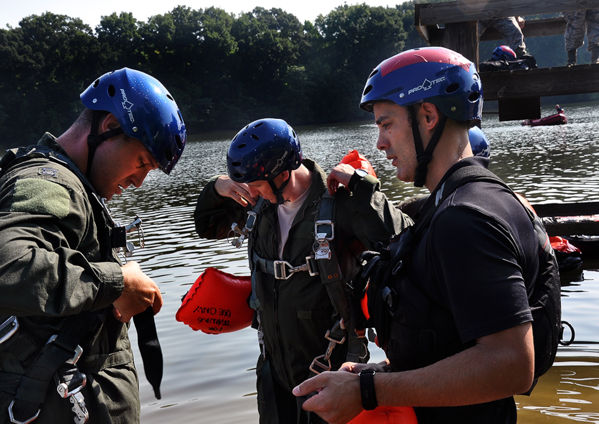 Staff Sgt. Cody Speckman helps a member of the 357th Airlift Squadron prepare for a class in water survival techniques.