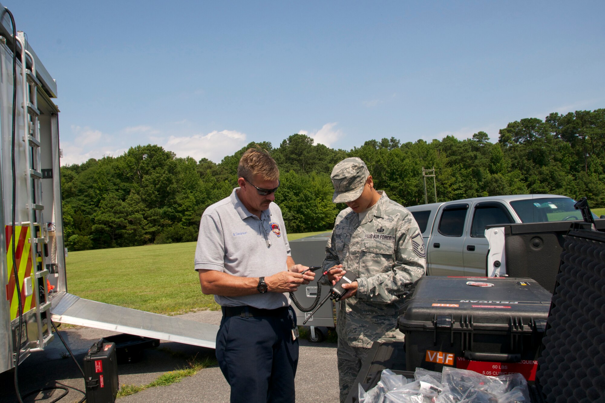 A 192d Intelligence Squadron member (right) and a Chesterfield Incident Management Team member talk about a cable solution to the land mobile radio. Members’ of the 192d Intelligence Squadron, the Virginia Joint Forces Headquarters, Civil Air Patrol and local emergency response agencies participated in an Incident Awareness and Assessment (IAA) exercise at Camp Pendleton, Virginia Beach, Virginia, July 22, 2015. (U.S. Air National Guard photo by Master Sgt. Carlos J. Claudio/Released)