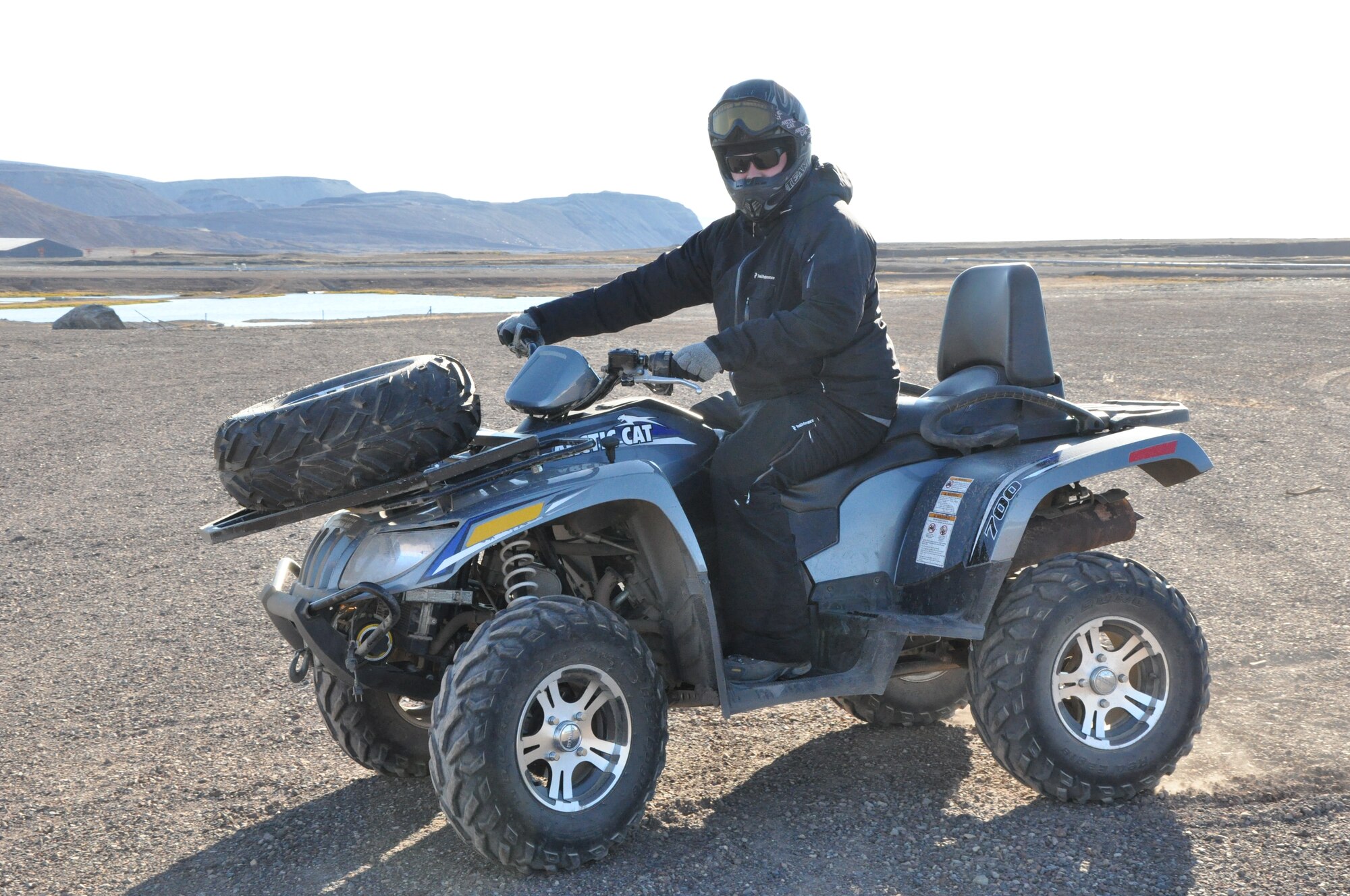 THULE AIR BASE, Greenland -- Thor Holton, an information technology specialist with Greenland Contractors, takes part in an ATV tour Aug. 12, 2015 at Thule AB. The two-hour ride over the North Mountain to a waterfall is part of the services program at Thule. Also offered in the services program are boat tours, go-karts in the summer, a library, outdoor recreation equipment rentals, fitness center, bowling alley, game room, and the Top of the World Club; a combination restaurant, bar and ballroom, which hosts most of the special events on base. Thule is located 750 miles north of the Arctic Circle, and relies on a tight-knit community in its remote location. (U.S. Air Force photo by Steve Brady)