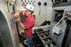 Randy Vinke, an ATA electrician with the Propulsion Wind Tunnel (PWT) Facility Test Operations group, installs wires for the interface panels that are used to connect the test model instrumentation to a data system.  The installation occurs in the PWT four-foot Transonic Wind Tunnel (4T) Captive Trajectory Support (CTS) system, which contains a newly designed and fabricated mechanism that enables a test model to have six degrees of motion: pitch, roll, yaw, axial, horizontal and vertical. The CTS is used to conduct staging and store separation testing. (Photo by Rick Goodfriend)