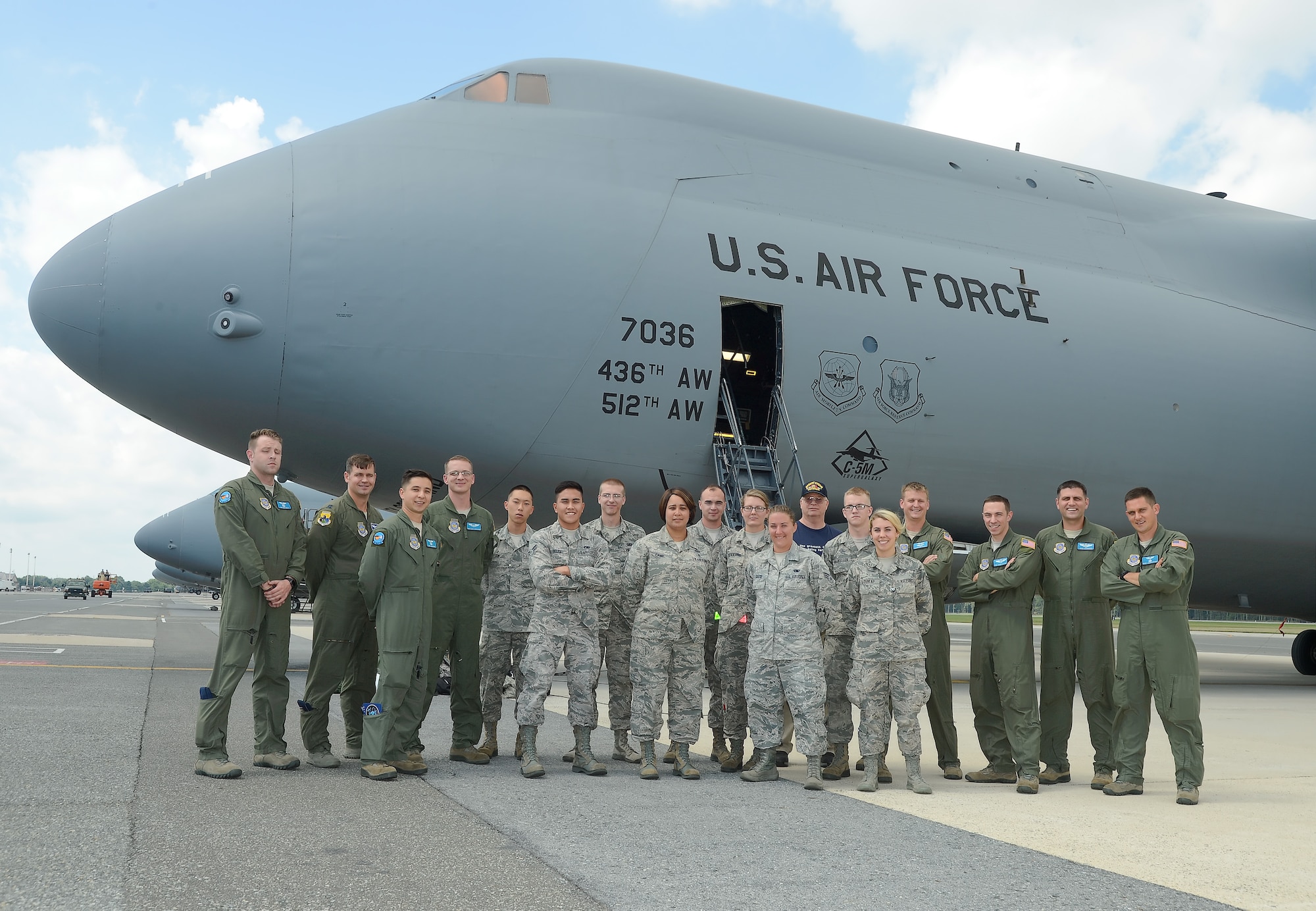 Aircrew and incentive flyers pose together with the C-5M Super Galaxy of the 436th Airlift Wing after their flight Aug. 11, 2015, Dover Air Force Base, Del. The incentive flyers were award winners and observed a training mission that included air-refueling from a KC-135R Stratotanker of the Pennsylvania Air National Guard. (U.S. Air Force photo/Greg L. Davis)