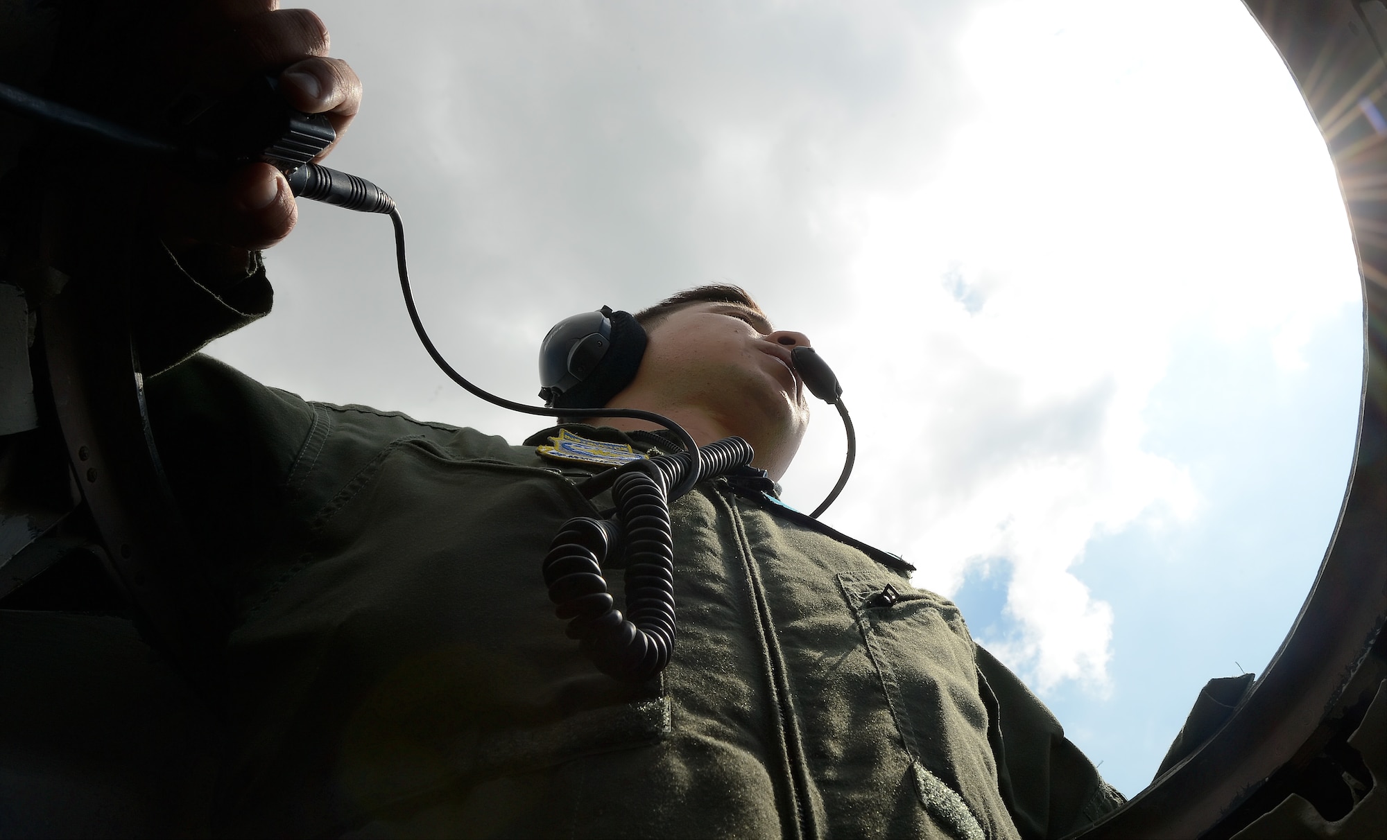 Tech. Sgt. Jon Meyers, 9th Airlift Squadron C-5M Super Galaxy flight engineer instructor looks out from the flight deck???s top emergency exit hatch as the aircraft taxis to park Aug. 11, 2015, at Dover Air Force Base, Del. Meyers kept a close watch to ensure the massive aircraft had ample clearance from other aircraft and fixed objects. (U.S. Air Force photo/Greg L. Davis)