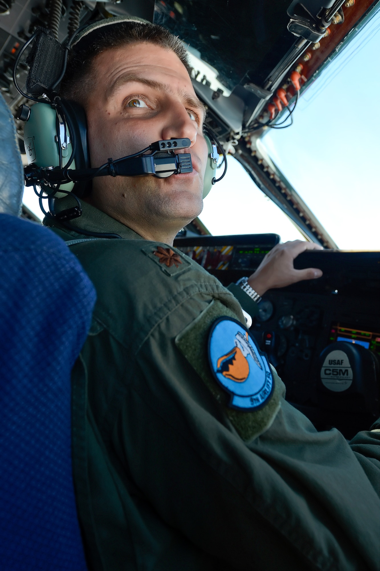 Maj. Jacob Scherrer, 9th Airlift Squadron C-5M Super Galaxy pilot and operations officer, looks over his shoulder to monitor the position of a KC-135R Stratotanker during a rendezvous as part of a training mission Aug. 11, 2015, from Dover Air Force Base, Del. Scherrer will conduct refueling training once the tanker aircraft has moved into position in front of the C-5M. (U.S. Air Force photo/Greg L. Davis)