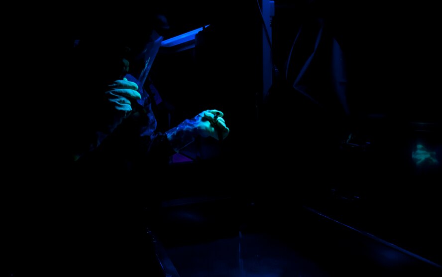 Airman 1st Class Atreyeu C. Taylor, 92nd Maintenance Squadron nondestructive inspection journeyman, removes a part from a solution while conducting a penetrant inspection July 22, 2015, at Fairchild Air Force Base, Wash. Penetrant inspections detect discontinuities open to the surface on parts made of nonporous materials. (U.S. Air Force photo/Airman Sean Campbell)