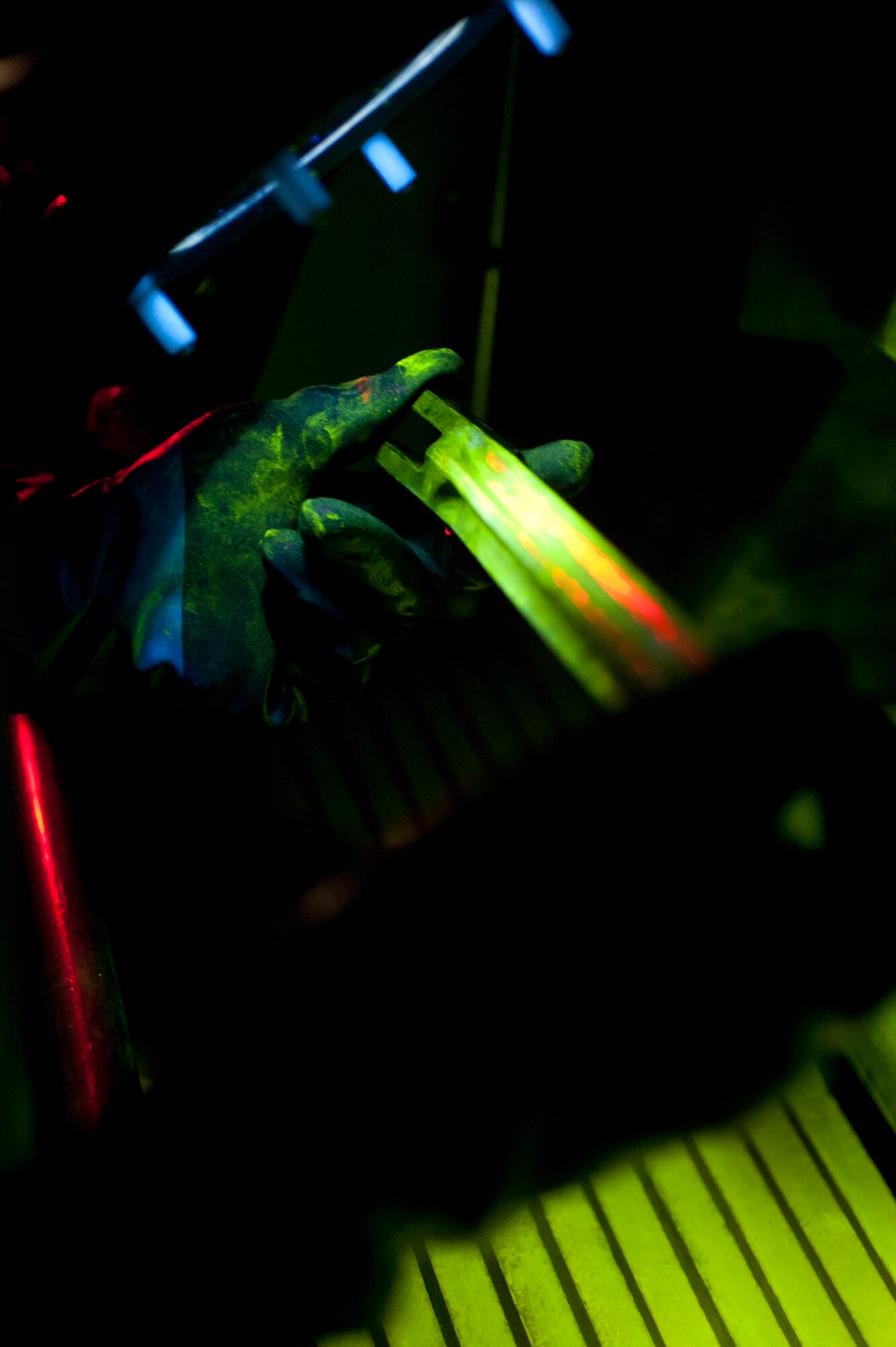 Airman 1st Class Atreyeu C. Taylor, 92nd Maintenance Squadron nondestructive inspection journeyman, examines a part while conducting an inspection July 22, 2015, at Fairchild Air Force Base, Wash. If NDI missed a breakage, it could cause further damage to the aircraft or possible death. (U.S. Air Force photo/Airman Sean Campbell)