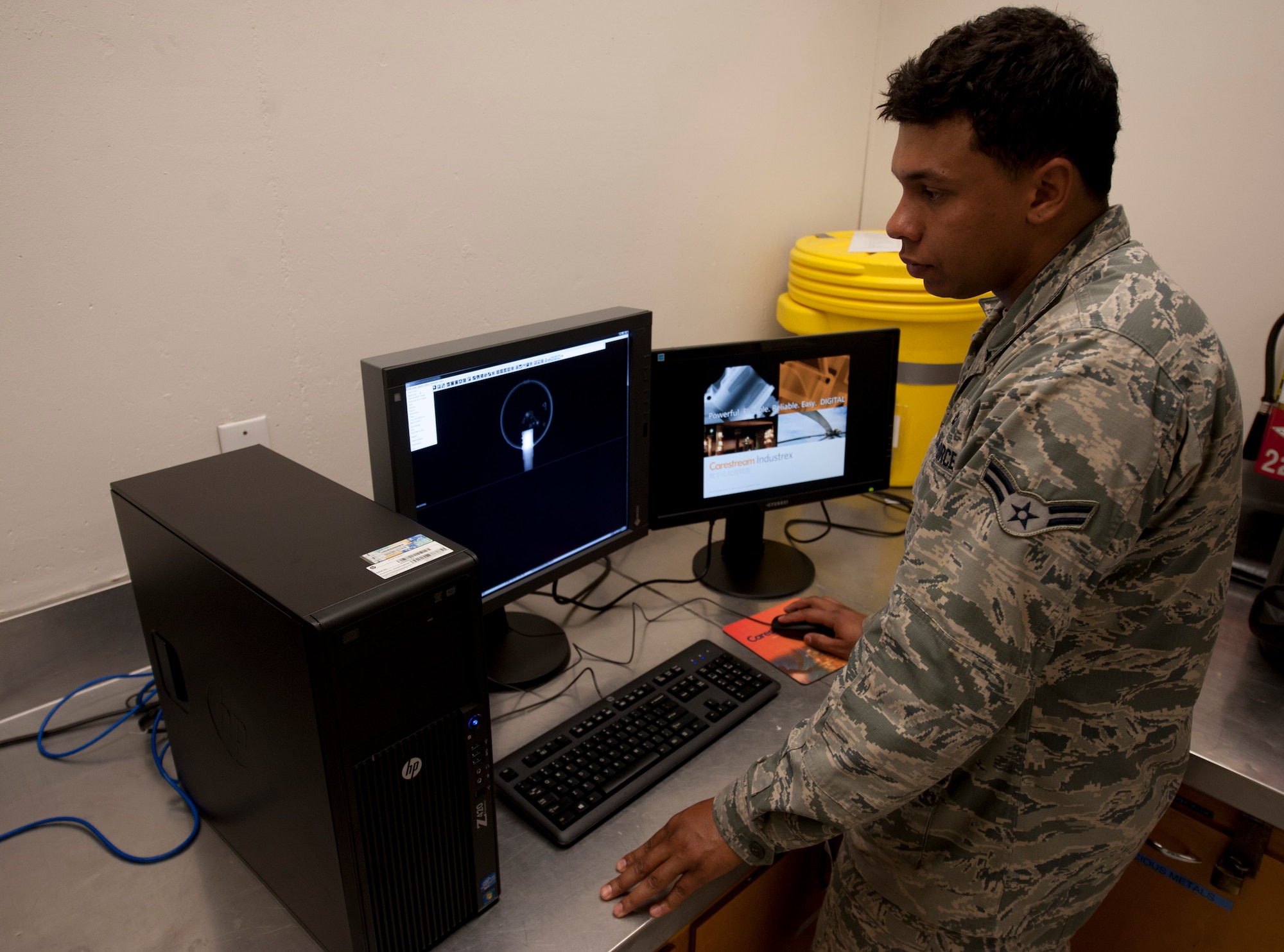 Airman 1st Class Atreyeu C. Taylor, 92nd Maintenance Squadron nondestructive inspection journeyman, operates the new digital machine used to certify welders July 22, 2015, at Fairchild Air Force Base, Wash. This new machine removed the outdated procedure of developing film from the welding certification process. (U.S. Air Force photo/Airman Sean Campbell) 