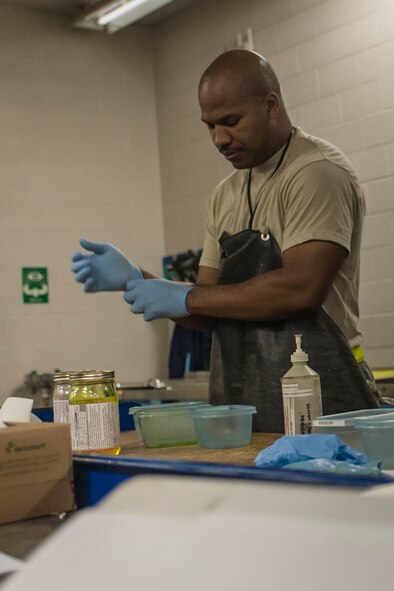 Staff Sgt. Christopher Hooper, 92nd Maintenance Squadron nondestructive inspection journeyman, cleans up his work area after conducting an inspection July 9, 2015, at Fairchild Air Force Base, Wash. The NDI shop has a complete integration of Air National Guard and active duty. (U.S. Air Force photo/Airman Sean Campbell)