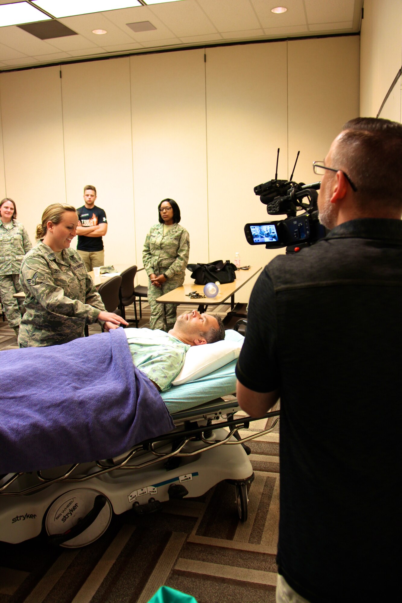 Members of the 932nd Aeromedical Staging Squadron listen to emergency patient instructions from Christopher Boyer (off camera) who is a Mercy Hospital Nurse Fellowship Coordinator. The "patient" in this scenario was the 932nd Airlift Wing commander, Col. Karl Goerke.  Video was captured by Chris Parr, public affairs specialist while members of the 932nd Medical Group participated in training and assisted where needed during their two week annual tour, part of which was utilized in updating training records after courses like this one held at Mercy. The program was initiated by Maj. Edward Hubble who works at the hospital but is also part of the 932nd Airlift Wing.  (U.S. Air Force photo by Maj. Stan Paregien)
