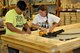 KNOXVILLE, Tenn. - Tech. Sgt. Kalon Pang and Master Sgt. Cindy Dickson, instructors assigned to the I.G. Brown Training and Education Center on McGhee Tyson Air National Guard Base, assemble a doorframe August 18, 2015, that will be used in a home building project. About a dozen military volunteers took part in the two-day Habitat for Humanity project here inside the organization's wood shop. (U.S. Air National Guard photo by Master Mike R. Smith/Released)