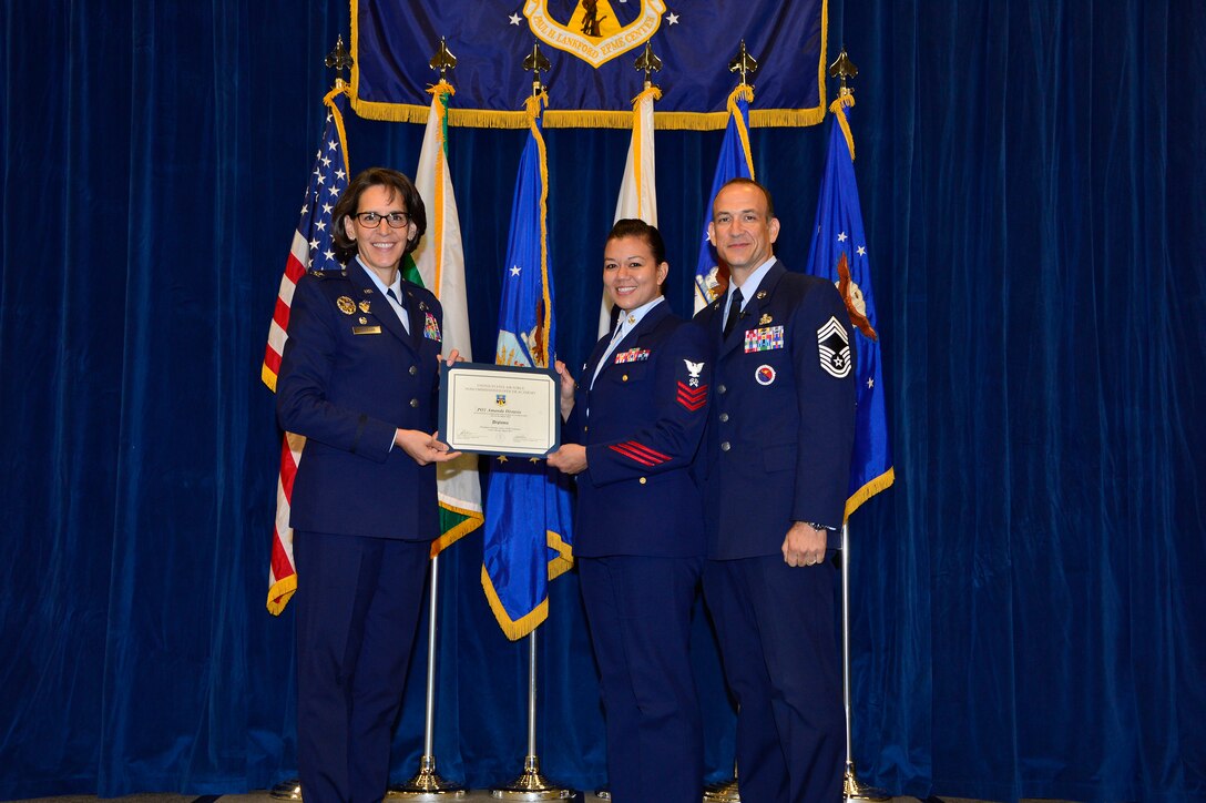 MCGHEE TYSON AIR NATIONAL GUARD BASE, Tenn. - Petty Officer 1st Class Amanda Distasio, receives her diploma from NCO academy Class 15-5  from Col. Jessica Meyeraan, commander of the I.G. Brown Training and Education Center and Chief Master Sgt. Edward Walden, commandant, here, August 13, 2015, at the I. G. Brown Training and Education Center. The TEC often hosts students from the Coast Guard at the Airman leadership School and NCO academy.  (U.S. Air National Guard photo by Master Sgt. Jerry D. Harlan/Released)