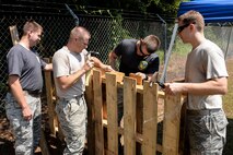 Airmen from the 4th Logistics Readiness Squadron construct their fort for the 3rd annual Combat Dining In, Aug. 14, 2015, at Seymour Johnson Air Force Base, North Carolina. Prior to the event, Airmen were given several hours to build up their defense using whatever materials they could find. (U.S. Air Force photo/Senior Airman Brittain Crolley)