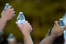 Airmen raise their drinks for a toast during the 3rd annual Combat Dining In, Aug. 14, 2015, at Seymour Johnson Air Force Base, North Carolina. Each member of the official party proposed a toast, including one to the colors, the President, the Chief of Staff, the Chief Master Sergeant of the Air Force, the sister services and other distinguished guests. (U.S. Air Force photo/Senior Airman Brittain Crolley)