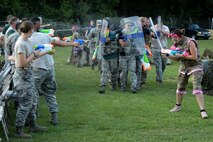 Members of the 4th Security Forces Squadron escort the official party to the stage during the 3rd annual Combat Dining In, Aug. 14, 2015, at Seymour Johnson Air Force Base, North Carolina. Once seated at the head table, the official party kicked off the event with several toasts. (U.S. Air Force photo/Senior Airman Brittain Crolley)