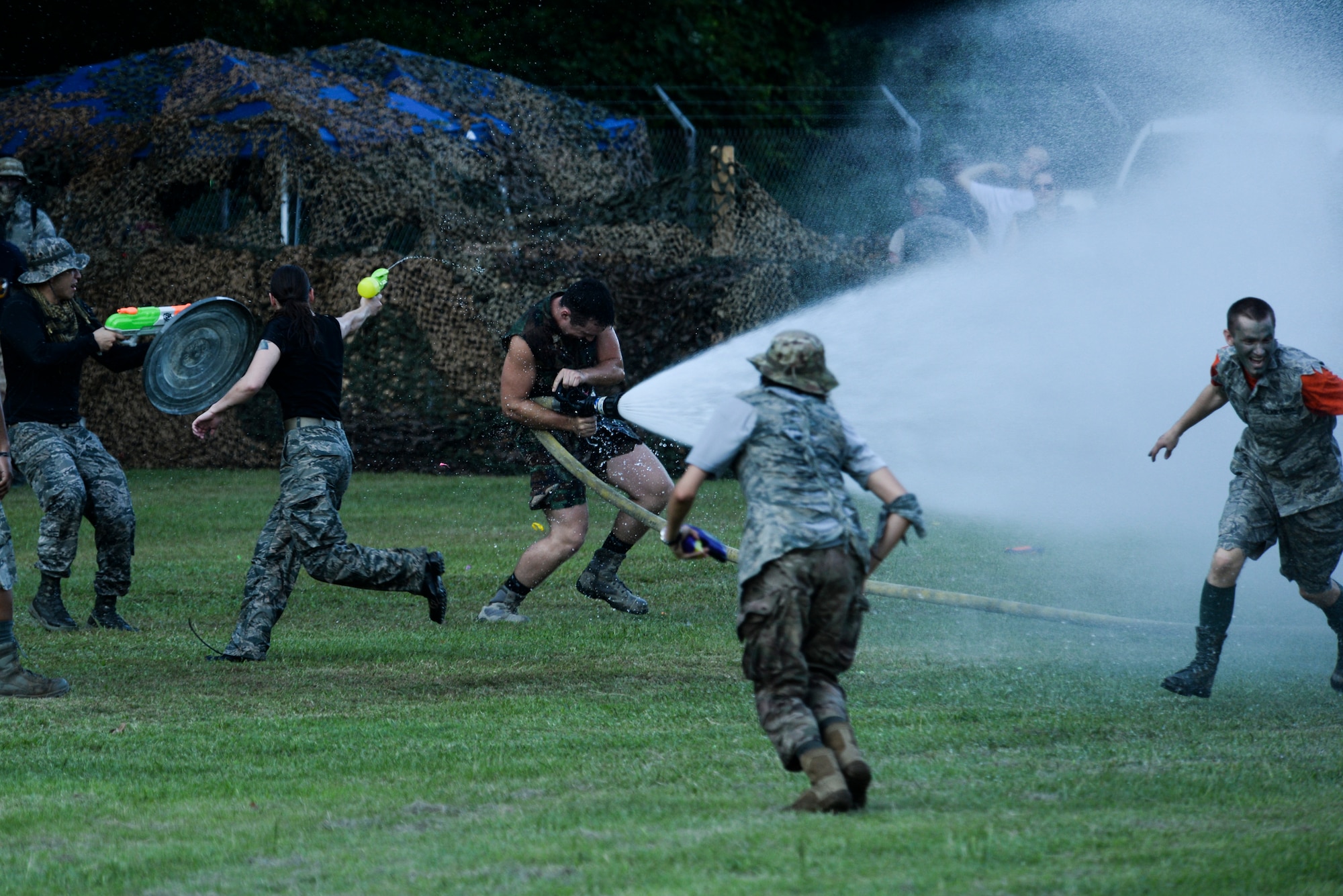 Senior Airman Michael Gilligan, 4th Civil Engineer Squadron firefighter, hoses down the competition during the 3rd annual Combat Dining In, Aug. 14, 2015, at Seymour Johnson Air Force Base, North Carolina. Gilligan’s advantage was short lived as Airmen quickly overtook his position and shut the hose down. (U.S. Air Force photo/Senior Airman Brittain Crolley)