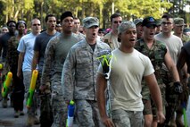 Members of the 4th Logistics Readiness Squadron march to the 3rd annual Combat Dining In, Aug. 14, 2015, at Seymour Johnson Air Force Base, North Carolina. Hundreds of Airmen from across the base descended upon the log cabin to enhance esprit de corps and battle for squadron superiority. (U.S. Air Force photo/Senior Airman Brittain Crolley)