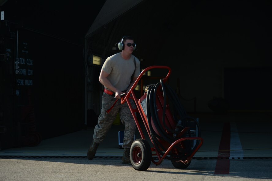U.S. Air Force Airman 1st Class Galen Eblin, a tactical aircraft weapons specialist assigned to the 52nd Aircraft Maintenance Squadron, wheels out emergency equipment while receiving an F-16 Fighting Falcon fighter aircraft assigned to the 480th Fighter Squadron as the aircraft returns to Spangdahlem Air Base, Germany, Aug. 7, 2015. The aircraft participated in RED FLAG, the U.S. Air Force's premier air-to-air combat training exercise at Nellis Air Force Base, Nevada, July 13-31, 2015. (U.S. Air Force photo by Staff Sgt. Joe W. McFadden/Released)