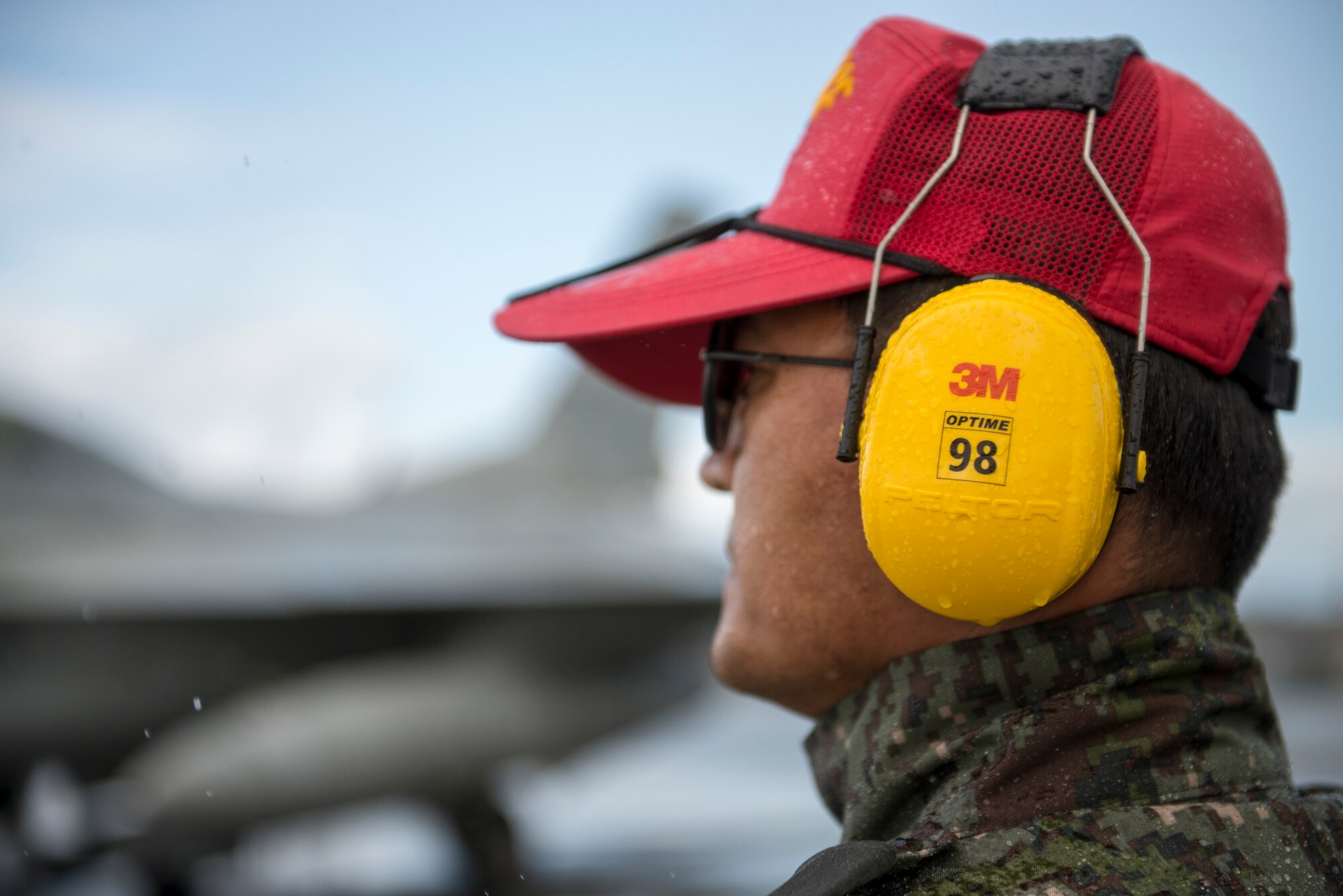 Republic of Korea Air Force (ROKAF) Warrant Officer Dongjun Lee, a ROKAF maintenance officer, waits through an unexpected rainstorm to marshal aircraft for a RED FLAG-Alaska (RF-A) 15-3 sortie, Aug. 11, 2015 at Eielson Air Force Base, Alaska. RF-A sorties are conducted for the full two-weeks, rain or shine, barring extreme inclement weather, providing participants with unparalleled training in the world’s largest instrumented air, ground and electronic combat training range in the world, the Joint Pacific Alaska Range Complex. (U.S. Air Force photo by 1st Lt. Elias Zani/Released)