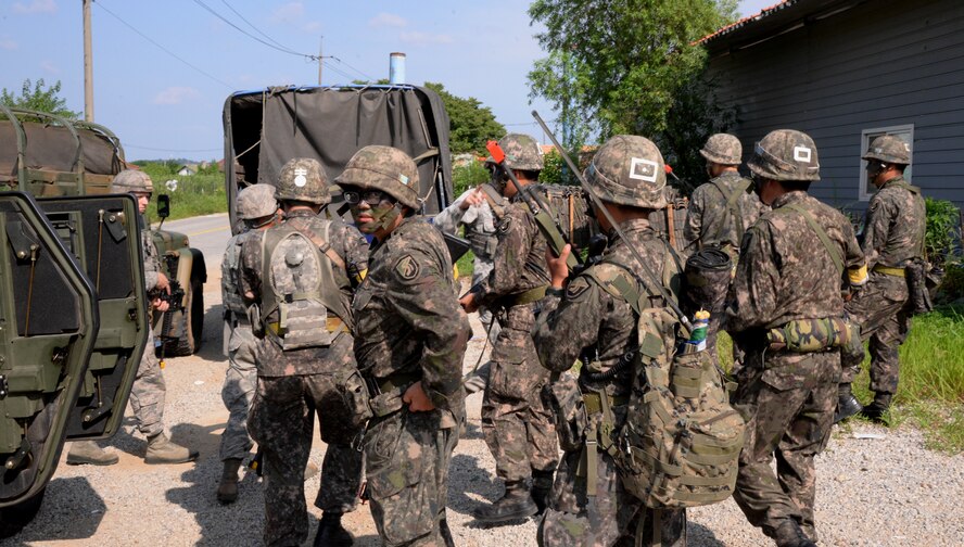 51st Security Forces Squadron and Republic of Korea Army members discuss patrol plans during an exercise simulation Aug. 18, 2015, near Pyeongtaek, South Korea. These combined forces enhance the ability of American and South Korean forces to make swift and coordinated tactical responses in the event of an emergency. (U.S. Air Force photo by Staff Sgt. Benjamin Sutton) 