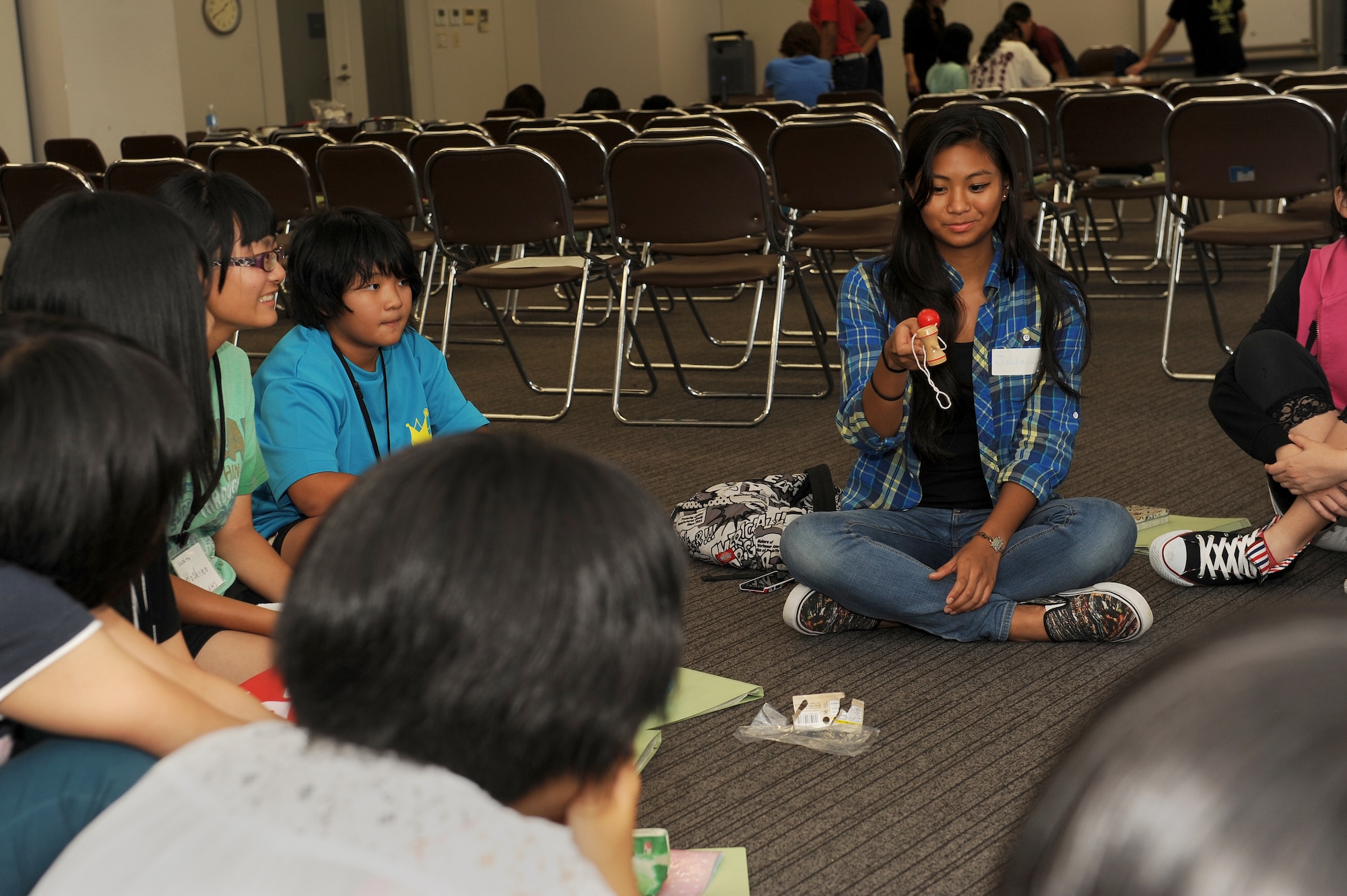 Jaida Martino, a Kadena High School student, plays with a traditional Japanese toy called a kendama at an English Summer Camp in Naha, Japan, Aug. 14, 2015. The two-day camp was designed to make Japanese elementary and middle school students more comfortable with their English speaking skills while allowing American and Japanese students to learn more about each other’s cultures. (U.S. Air Force photo by Airman 1st Class Zade C. Vadnais)