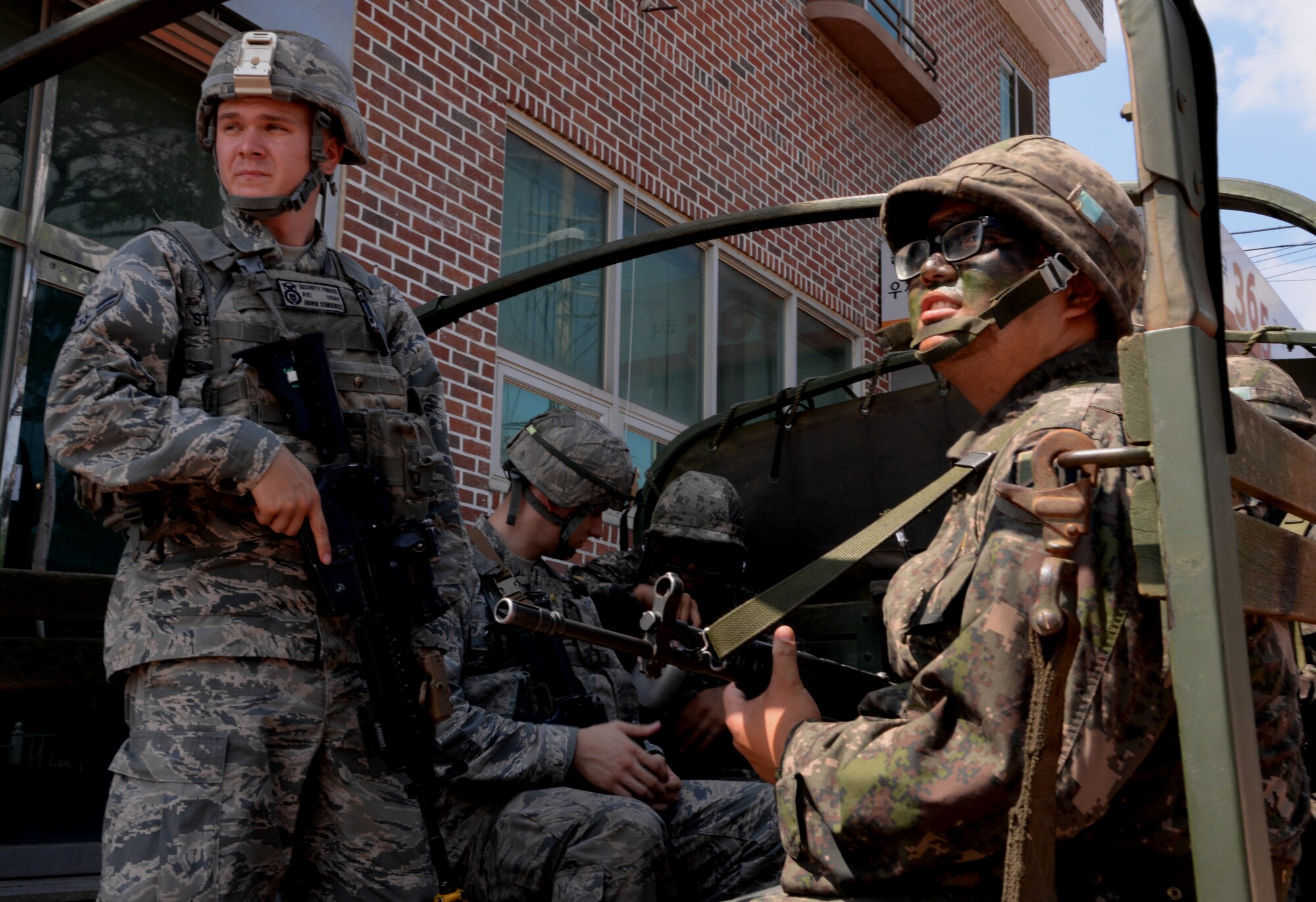 Airman 1st Class Andrew Stankiewicz, 51st Security Forces Squadron entry controller, receives final instructions before sitting down inside the back of a Republic of Korea Army truck Aug. 18, 2015, near Pyeongtaek, South Korea. Members of the 51st SFS and ROKA worked together to perform multiple patrols throughout the day as part of the readiness exercise Beverly Midnight 15-03. (U.S. Air Force photo by Staff Sgt. Benjamin Sutton)